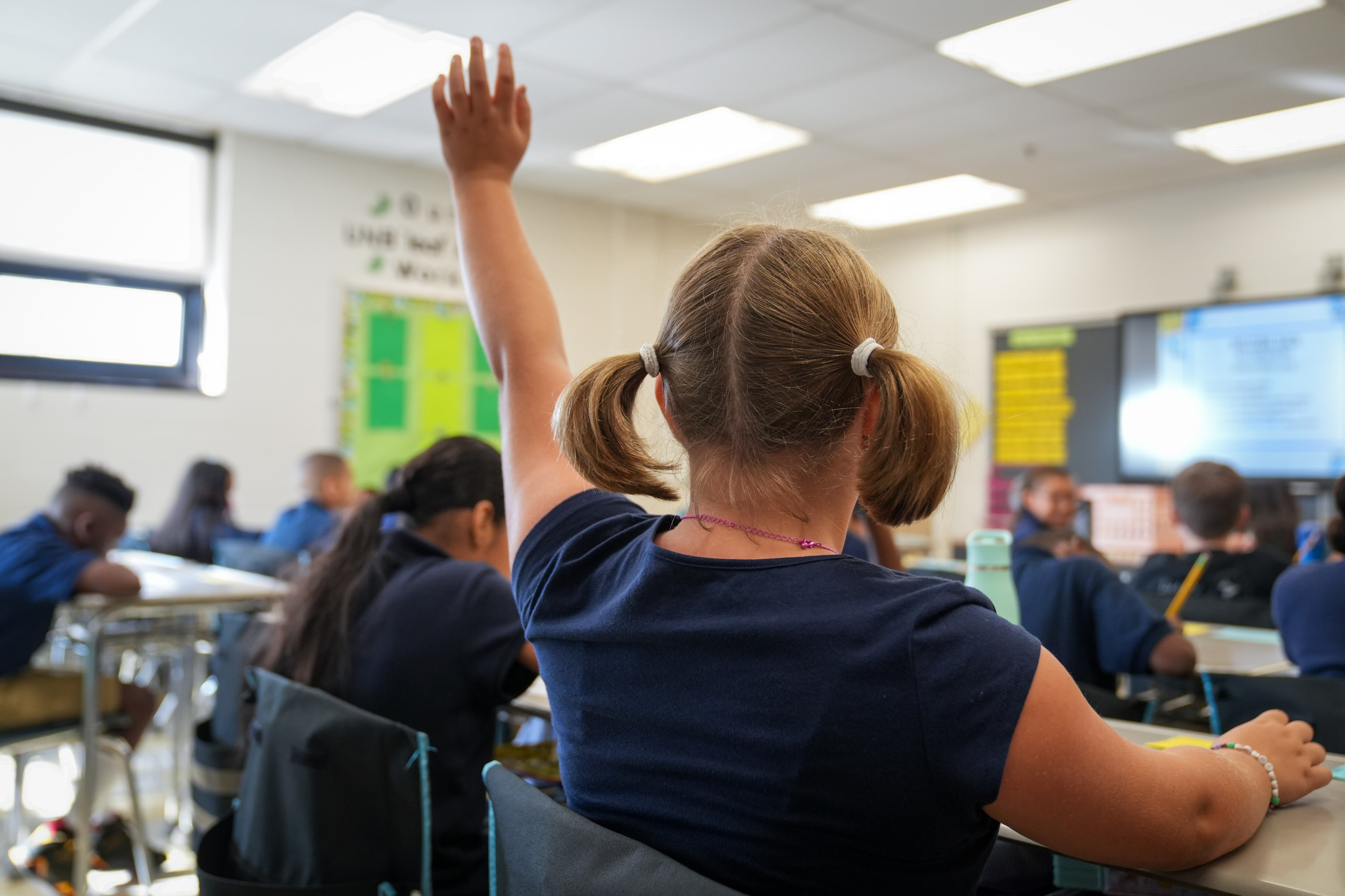 A student raises her hand to get the teacher’s attention inside Hampstead Hill Academy on 8/29/22. Monday was the first day back to school for Baltimore City students.