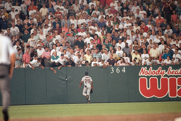 Barry Bonds of the San Francisco Giants chases down a ball that got stuck in the pads in left field during the 1993 All-Star Game at Camden Yards.