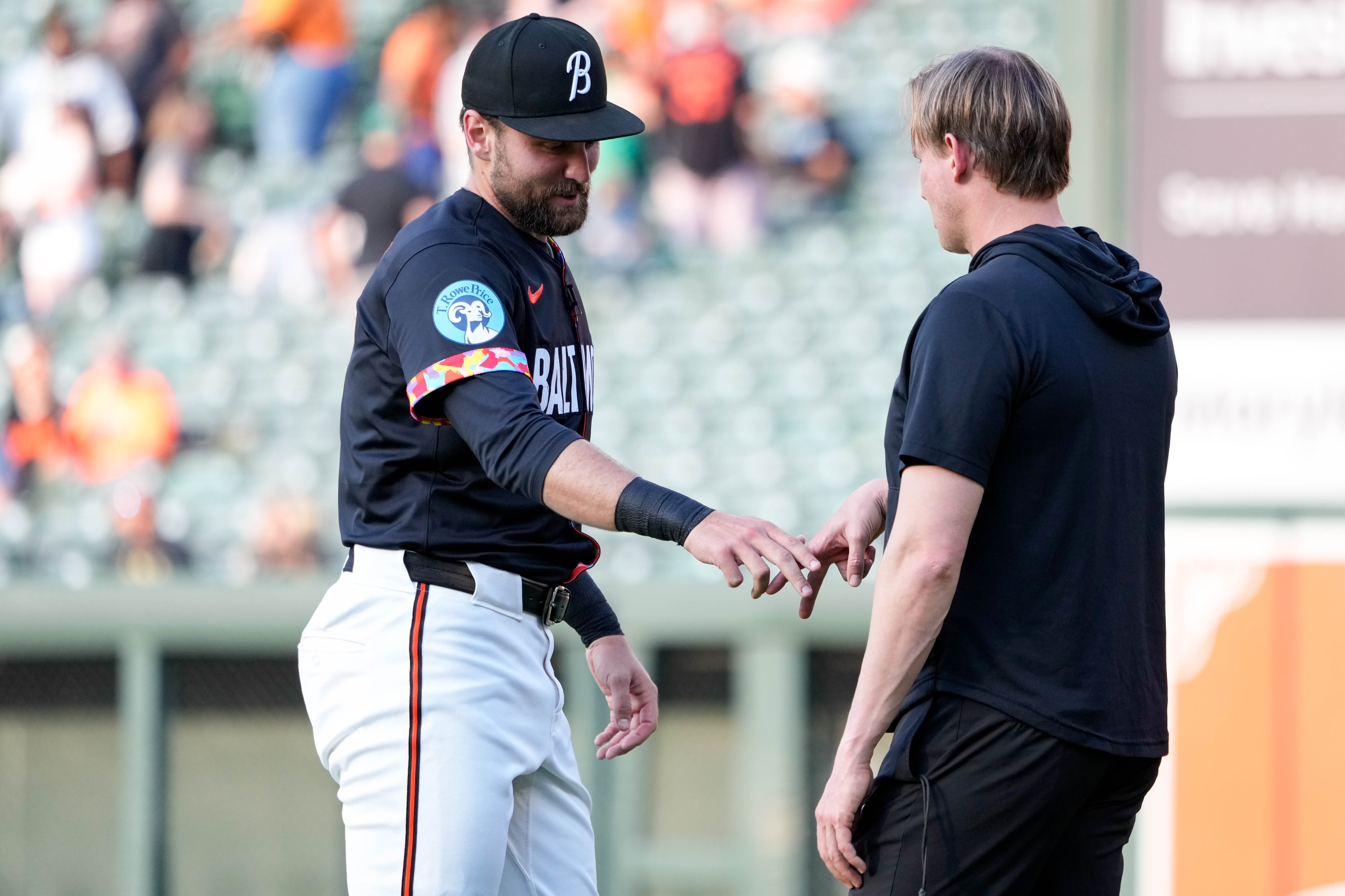 Orioles outfielder Colton Cowser completes his special handshake with strength coach Trey Wiedman before a game at Camden Yards last month.