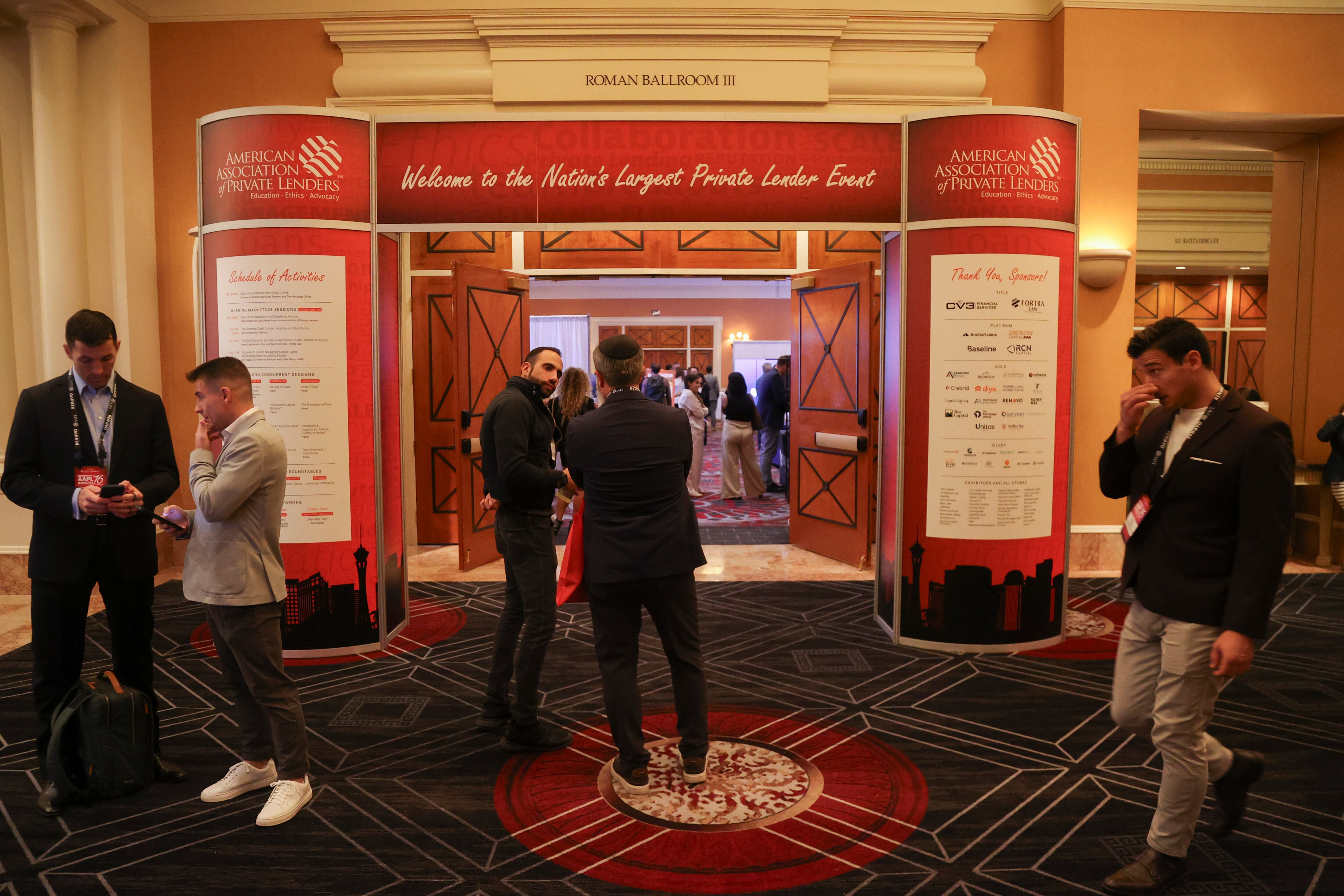 Attendees gather in a hallway at the American Association of Private Lenders conference at Caesars Palace in Las Vegas on Tuesday, Nov. 11, 2025. 
