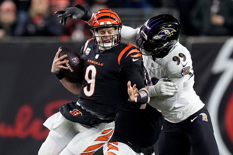 CINCINNATI, OHIO - JANUARY 15: Odafe Oweh #99 of the Baltimore Ravens sacks Joe Burrow #9 of the Cincinnati Bengals during the second quarter in the AFC Wild Card playoff game at Paycor Stadium on January 15, 2023 in Cincinnati, Ohio.
