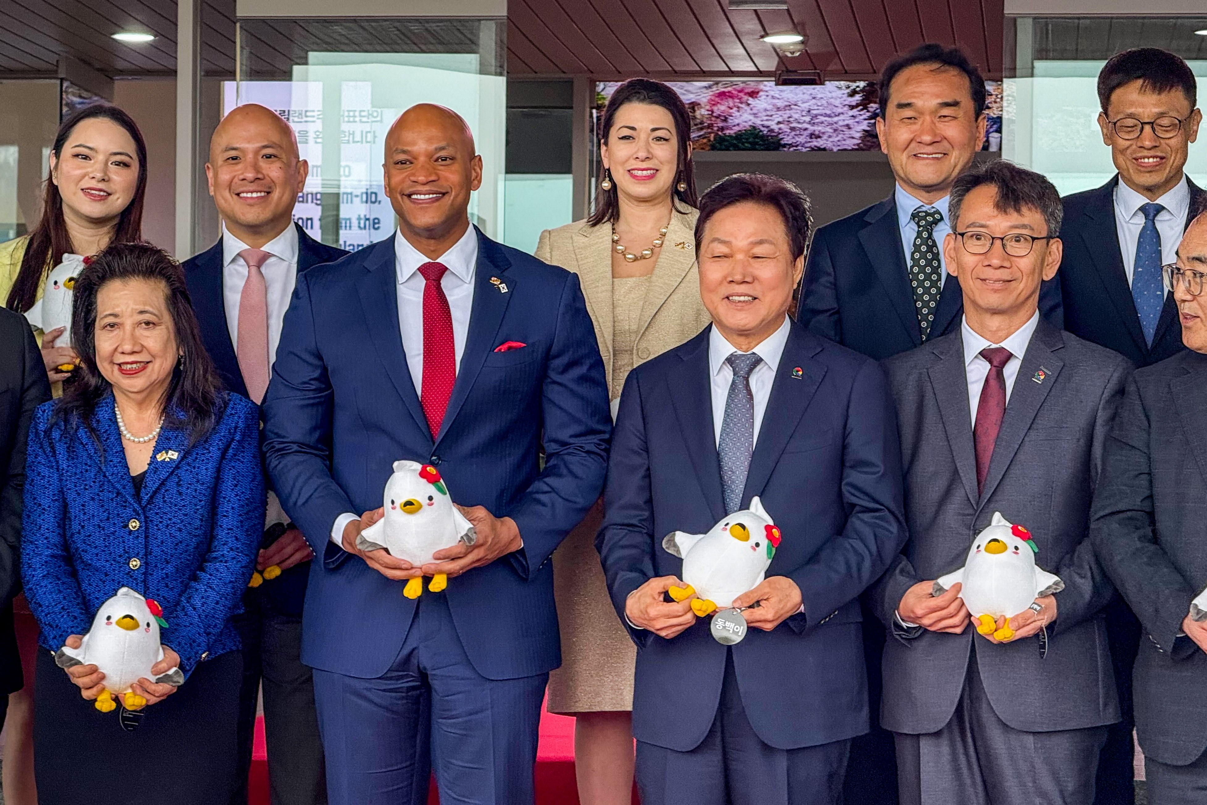 Gov. Wes Moore and his Korean counterpart Gov. Park Wan-Su of the South Gyeongsang Province pose for a group photo holding Dongbaeki plushies. Park presented the Maryland delegation with Dongbaeki toys. Dongbaeki, a gull, is a mascot of the South Korean city of Tongyeong.
