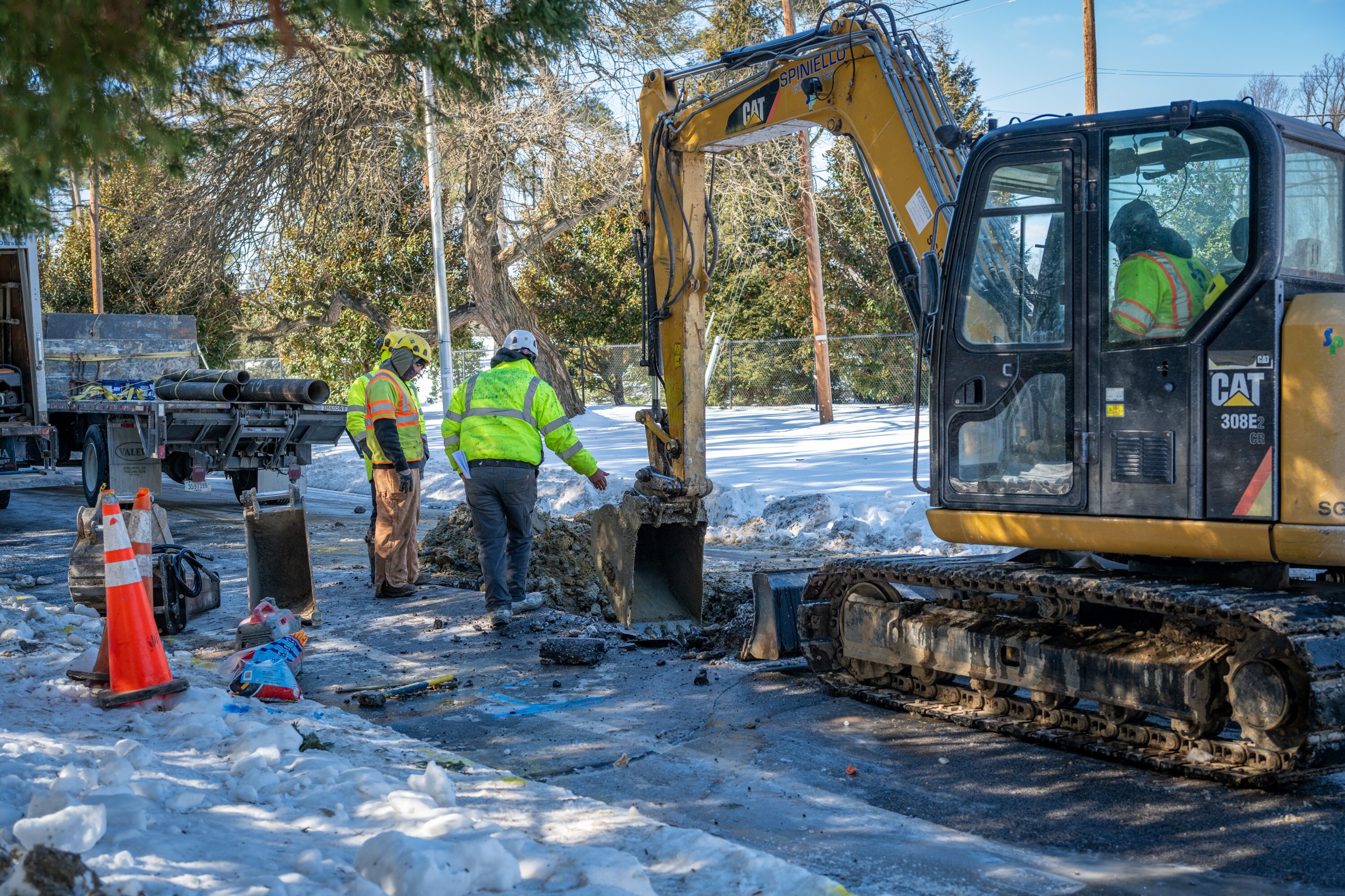 A work crew digs up Lake Avenue in Baltimore looking for a water main break Saturday.