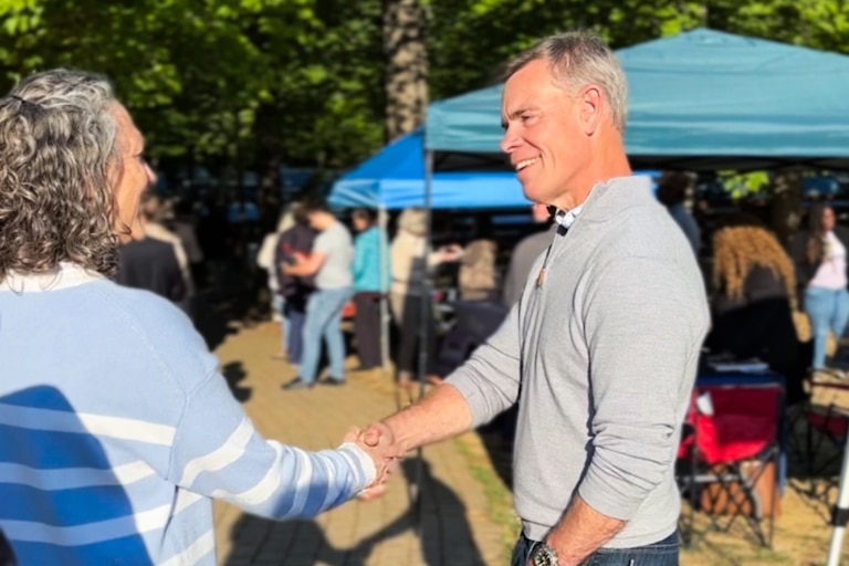 Dave Sundberg, an FBI official fired by the Trump administration now running for Congress, greets a voter at Running Hare Vineyard in Prince Fredrick, Maryland on May 7, 2026.