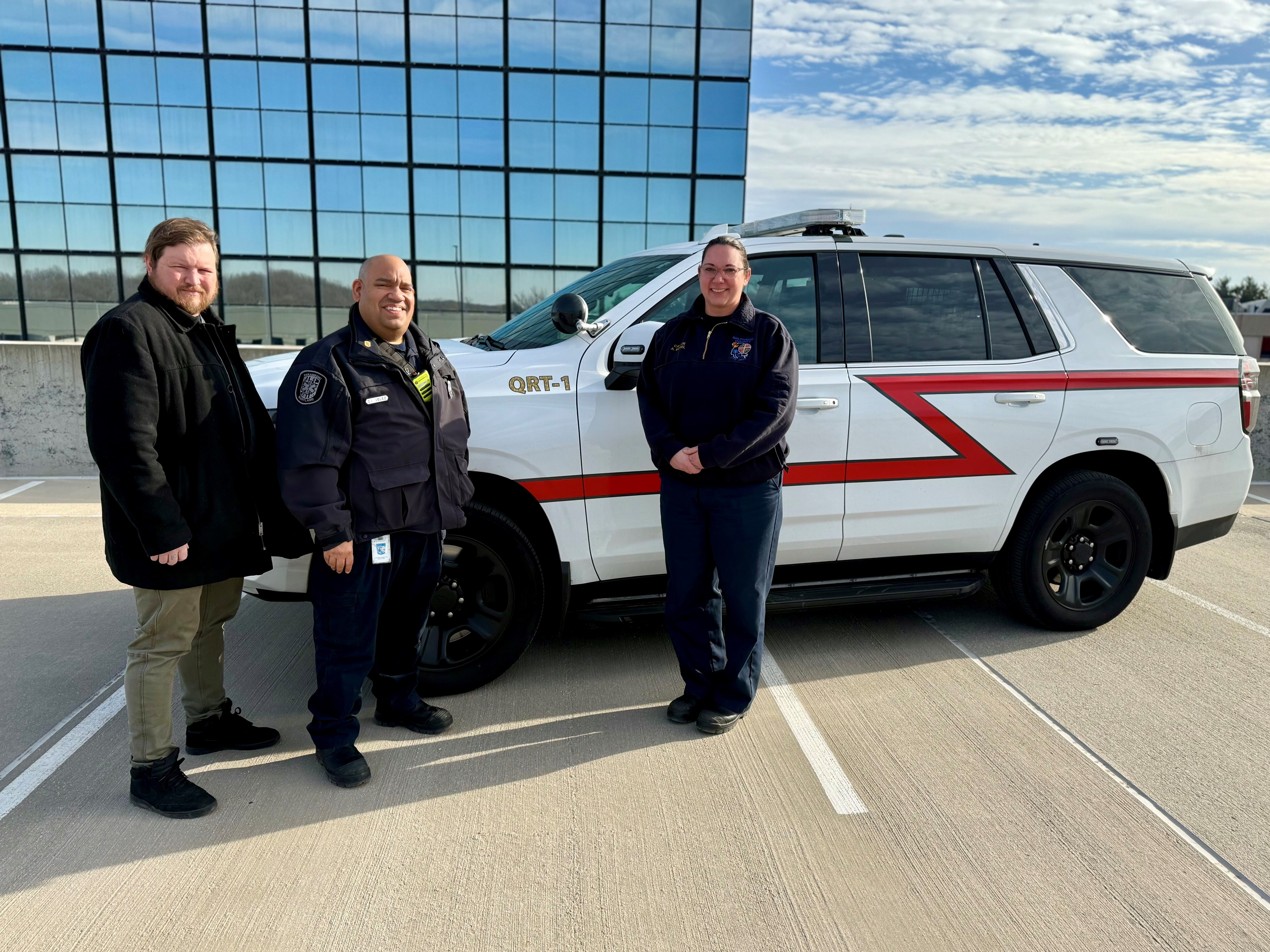 From left, certified peer recovery specialist Roger Miller, paramedic first class Carlos Velez and emergency medical services Capt. Amanda Wensel stand in front of a transport van the county's Quick Response Team uses in its overdose response efforts.