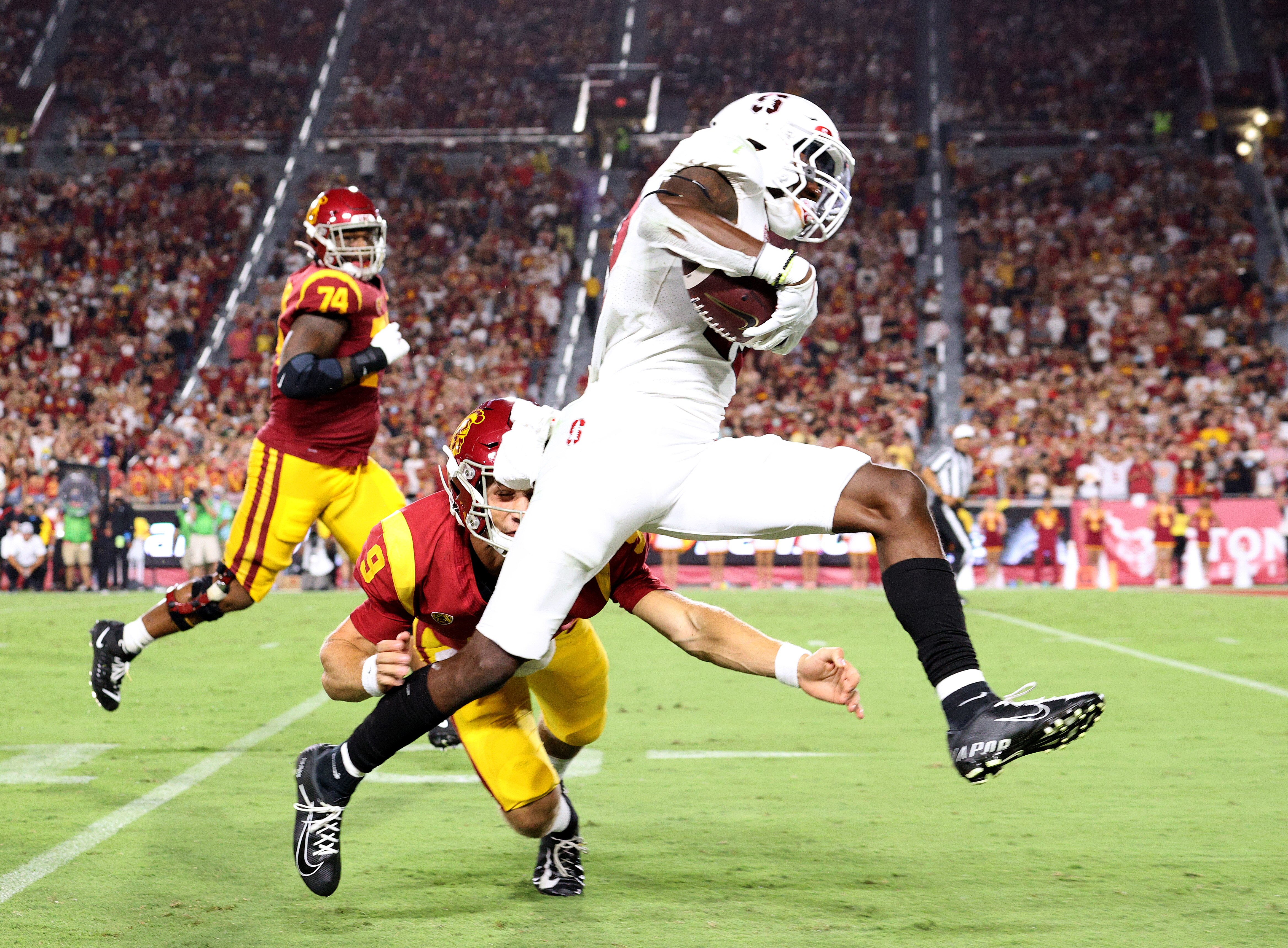 Kyu Blu Kelly #17 of the Stanford Cardinal runs back his interception past Kedon Slovis #9 of the USC Trojans for a touchdown during the third quarter at Los Angeles Memorial Coliseum on September 11, 2021 in Los Angeles, California.