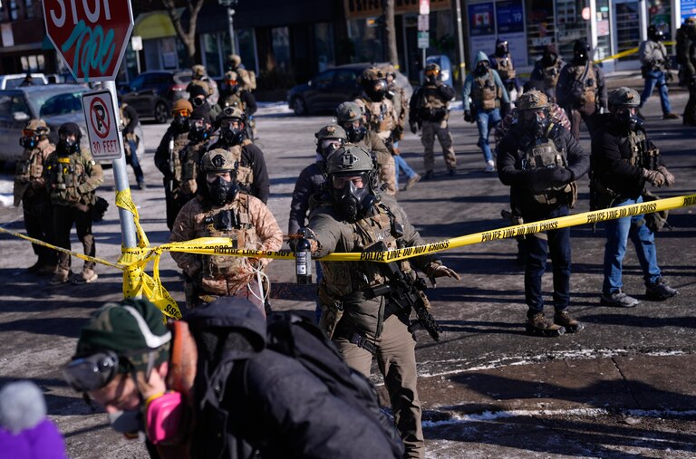Federal immigration officers deploy pepper spray at protesters after a shooting Saturday, Jan. 24, 2026, in Minneapolis.