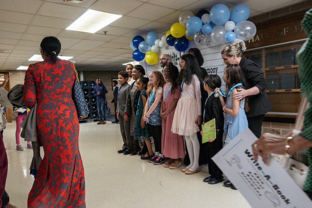 Students, teachers, and parents gather for group photos following the Write-A-Book ceremony.