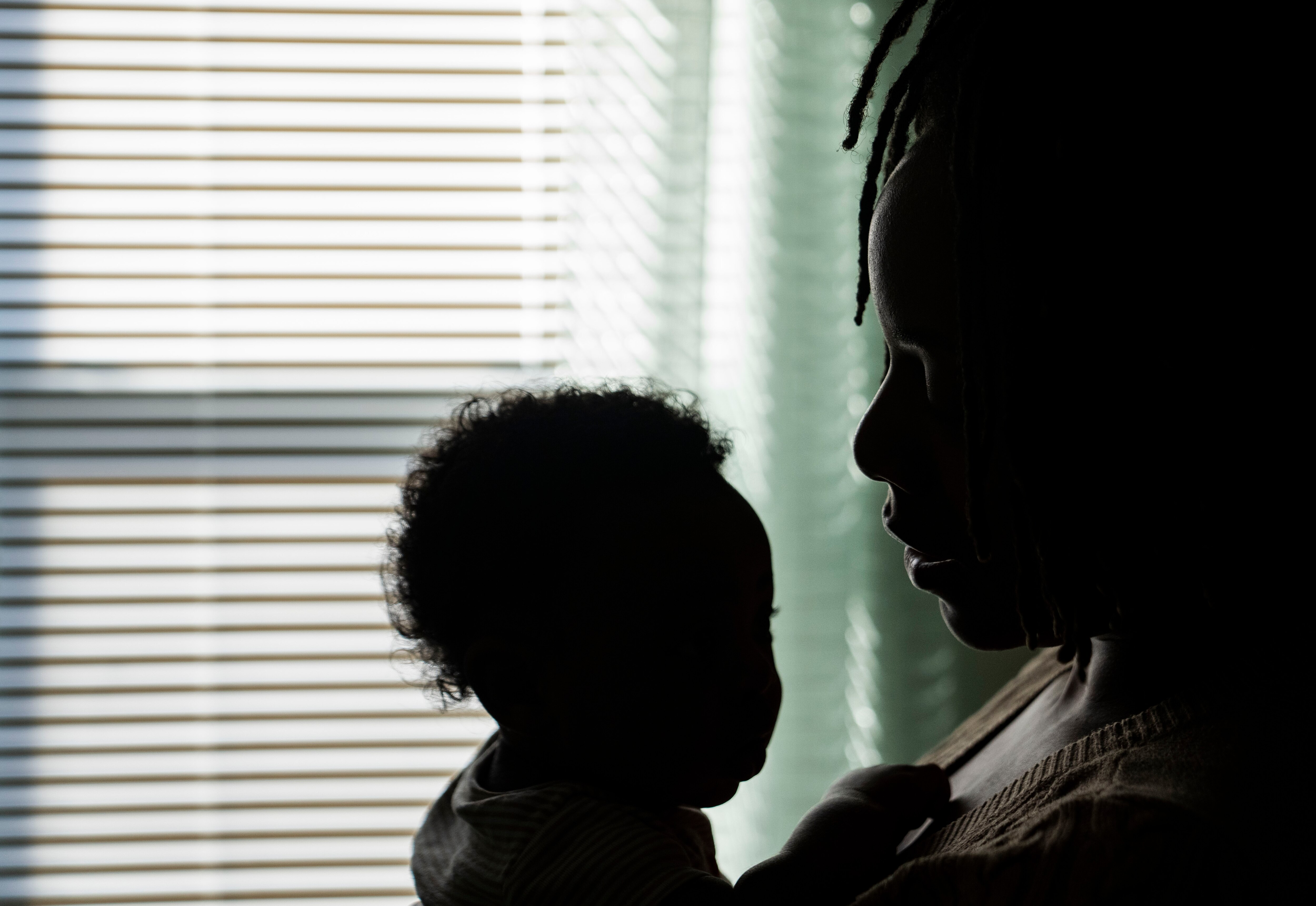 Jasmine Vaughn-Hall holds her son for a portrait inside of their home in Baltimore, Monday, October 28, 2024.