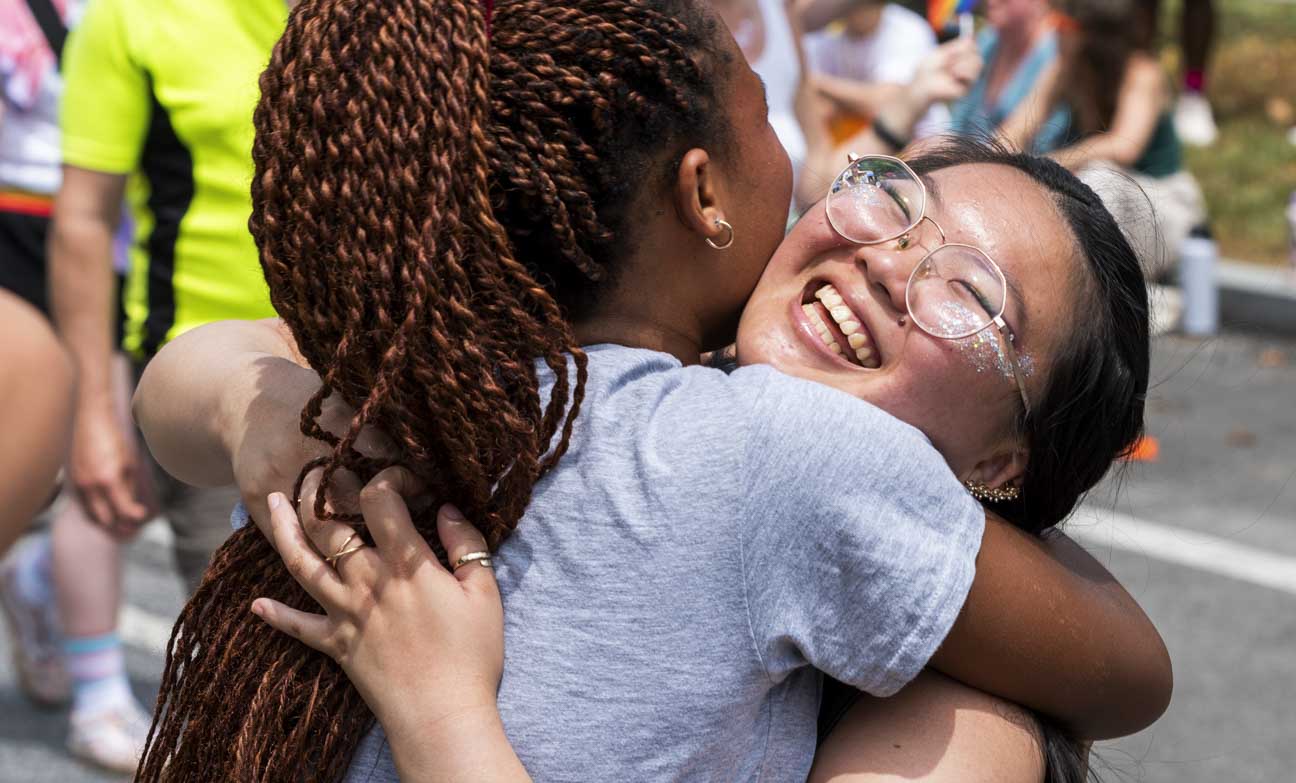 Rachel Baffoe-Bonnie, left, hugs Stephanie Ho, a parade participant with Johns Hopkins, at the Baltimore Pride Parade in Baltimore, Maryland.