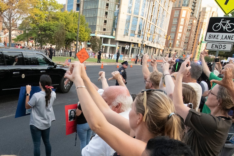 Protestors react as President Donald Trump's motorcade arrives Thursday, Sept. 12, 2019, in Baltimore. Trump makes his first visit to Baltimore since describing it nearly two months ago as a "disgusting, rat and rodent infested mess" where "no human being would want to live." Trump will be speaking to congressional Republicans attending an annual retreat in a hotel on the city's waterfront. (AP Photo/Tommy Gilligan)