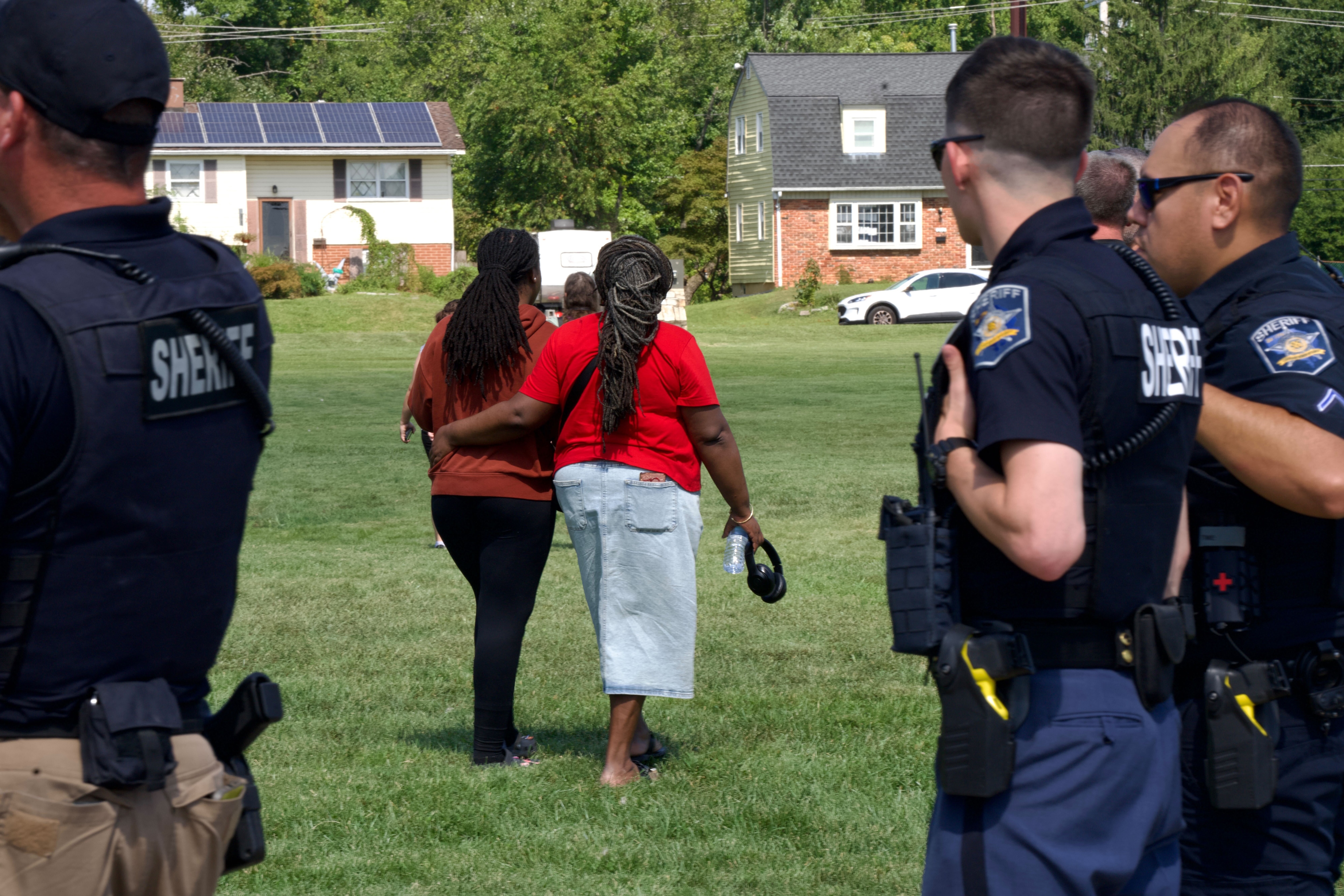 A guardian and student leave a reunification center near Joppetowne High School in Harford County, Friday, Sept. 6, 2024, after the sheriff's office and emergency personnel flocked to campus after a fight resulted in one student being injured.