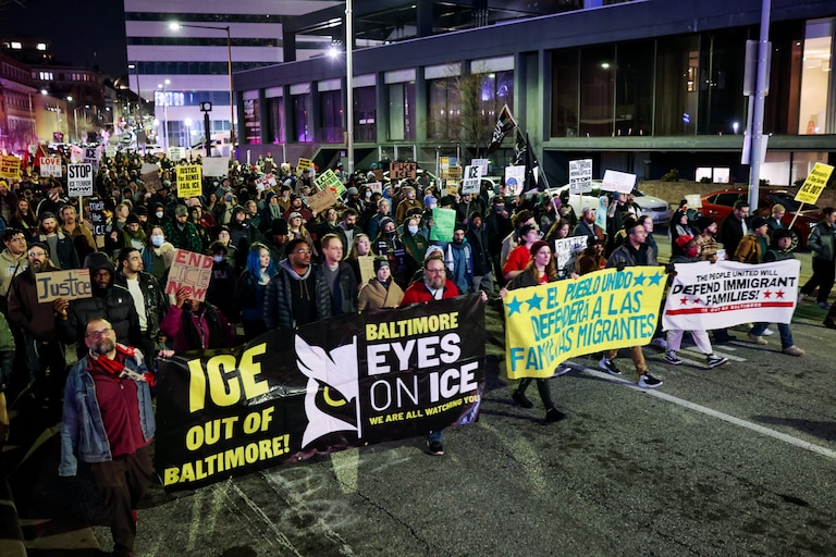 People march through downtown Baltimore to protest on Thursday after a woman was shot and killed by ICE in Minneapolis the previous day.