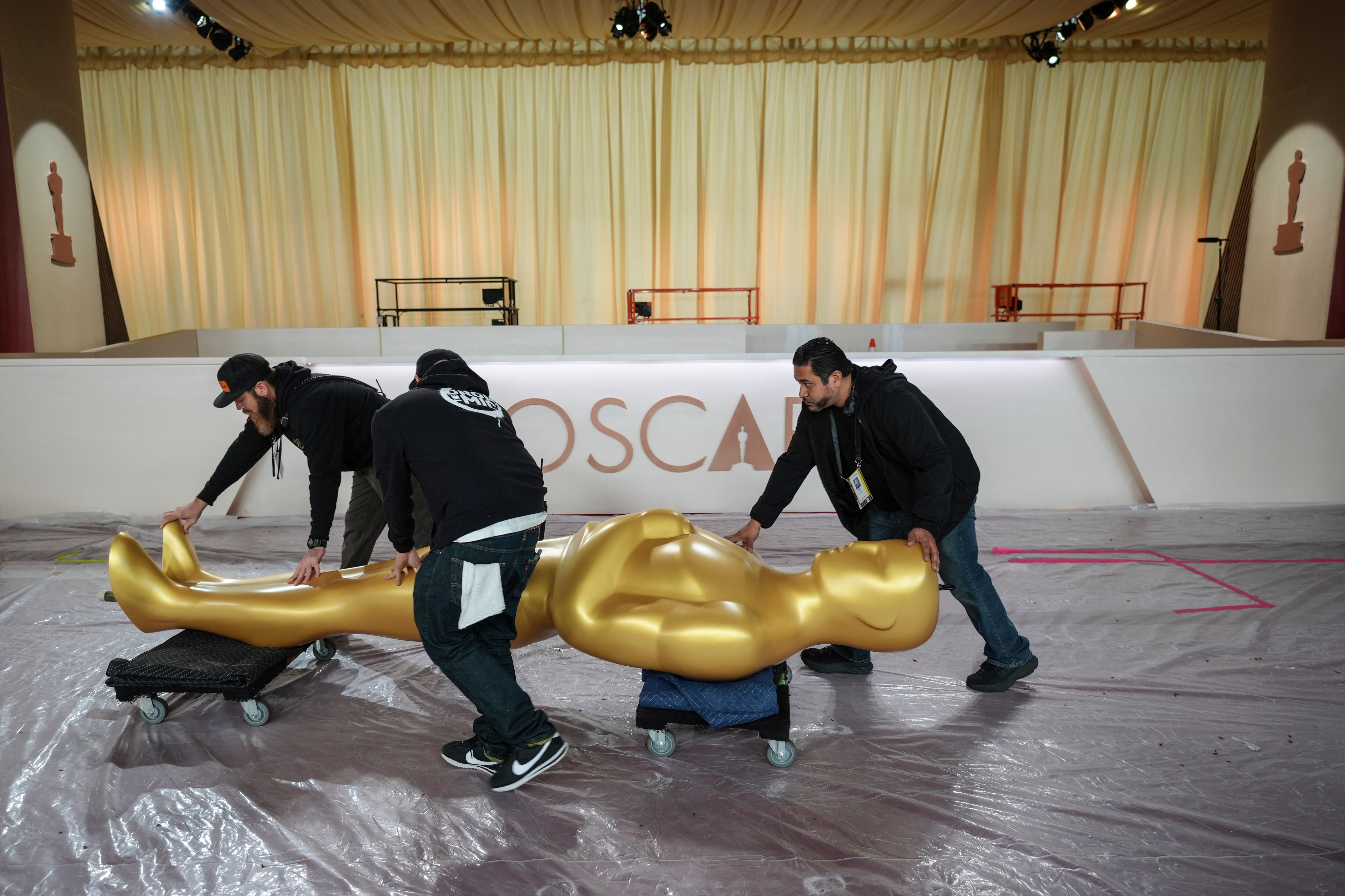 Workers on Saturday prepare for the 97th Academy Awards in Los Angeles.