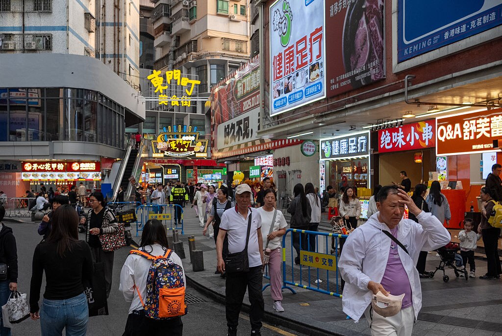 Shoppers walk on a street at a shopping district on April 03, 2025 in Shenzhen, China.