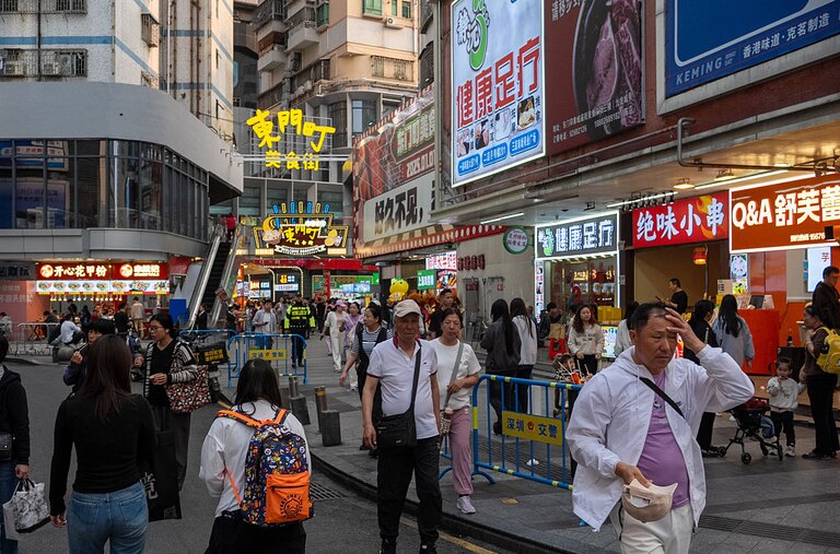 Shoppers walk on a street at a shopping district on April 03, 2025 in Shenzhen, China.