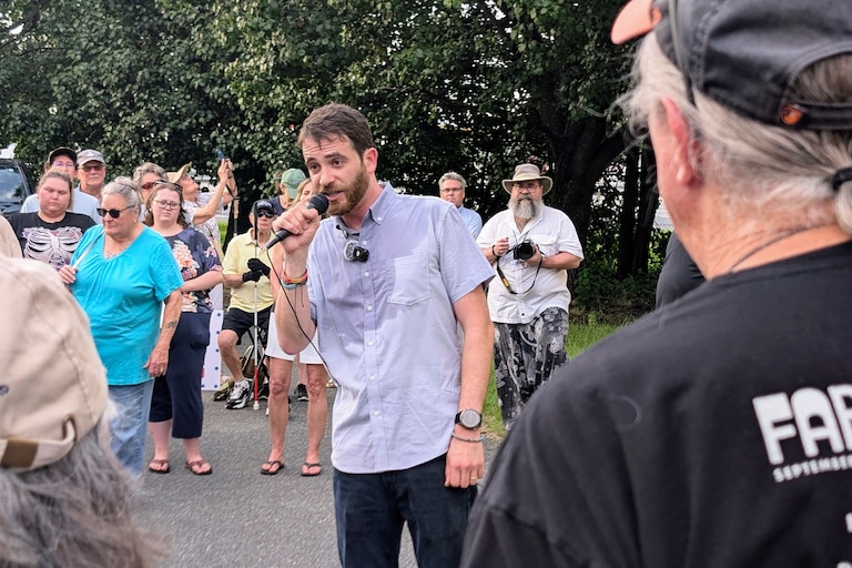 Dan Schwartz, the Democratic candidate for Congress in Maryland's 1st District, talks to a group of about 75 supporters July 22, 2026 on Kent Island. He was outside the closed district offices of his opponent, Rep. Andy Harris.