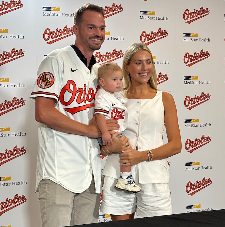 Trey Mancini, who signed a one-day contract to retire with the Orioles on Saturday, poses with his wife, Sara, and their daughter, Sadie