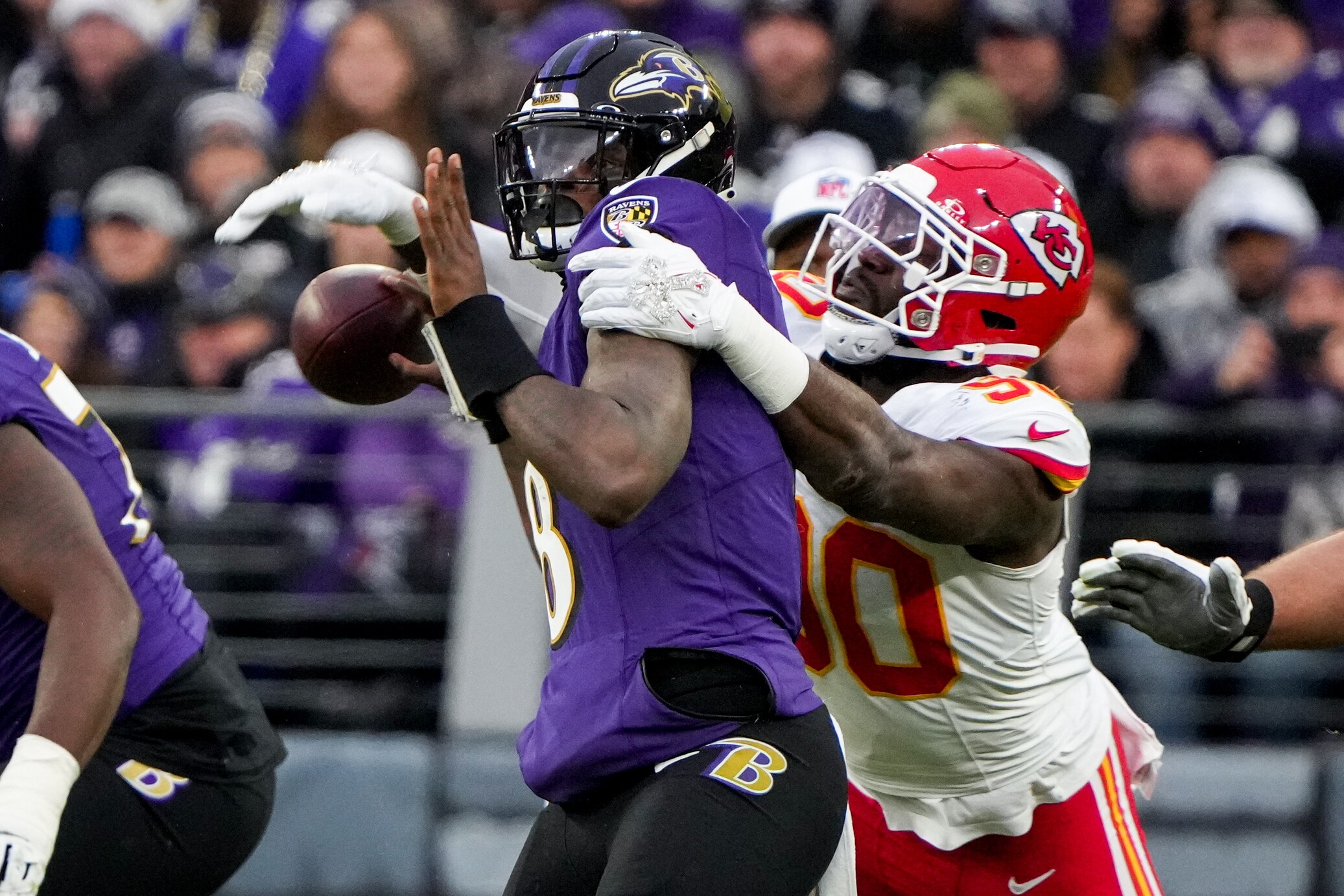 Kansas City Chiefs defensive end Charles Omenihu (90) forces Baltimore Ravens quarterback Lamar Jackson (8) to fumble in the second quarter of the AFC Championship game at M&T Bank Stadium on January 28, 2024. The Chiefs beat the Ravens, 17-10, to advance to the Super Bowl.