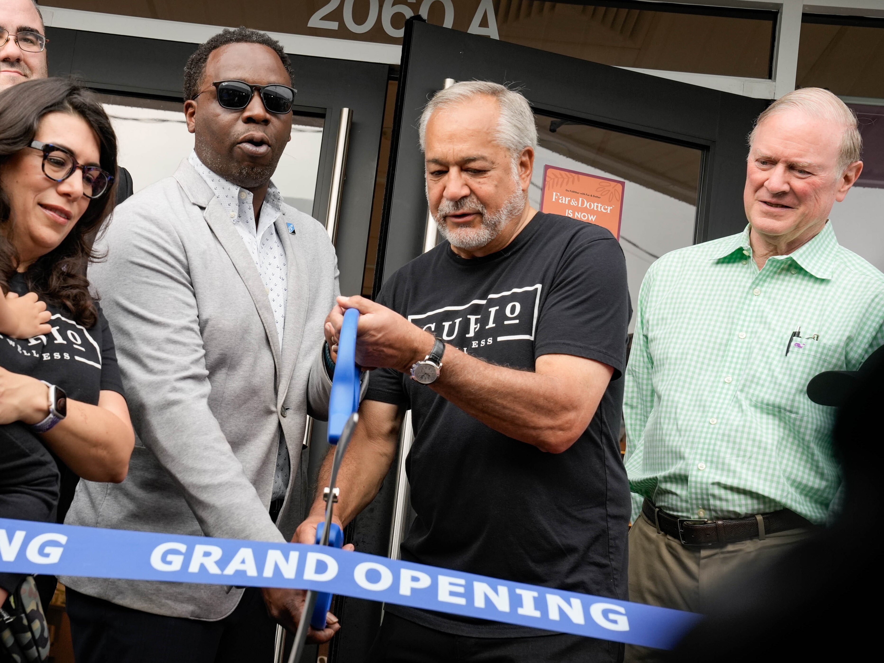President of the Baltimore County Chamber of Commerce Brent Howard cuts the ribbon with the CEO of Curio Wellness at the recreational grand opening of Far & Dotter on July 1, 2023, the first day of recreational cannabis legalization in Maryland.