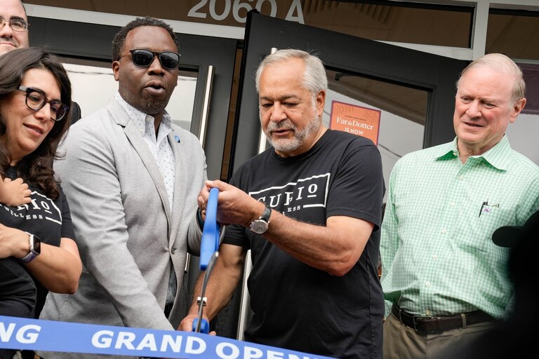 President of the Baltimore County Chamber of Commerce Brent Howard cuts the ribbon with the CEO of Curio Wellness at the recreational grand opening of Far & Dotter on July 1, 2023, the first day of recreational cannabis legalization in Maryland.