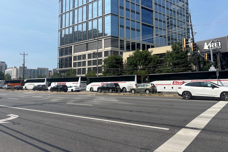 Charter buses line up outside the Pike and Rose shopping center to be used as shuttles to and from the North Bethesda Metro station.