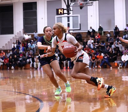 McDonogh's Makayla Quimby drives past Poly's MIckelle Lowry during Wednesday's  No. 1 vs. No. 2 girls basketball showdown. Quimby scores 18 points as the second-ranked Eagles built a 16-point first half lead en route to a 62-39 victory over No. 1 Engineers in Owings Mills.