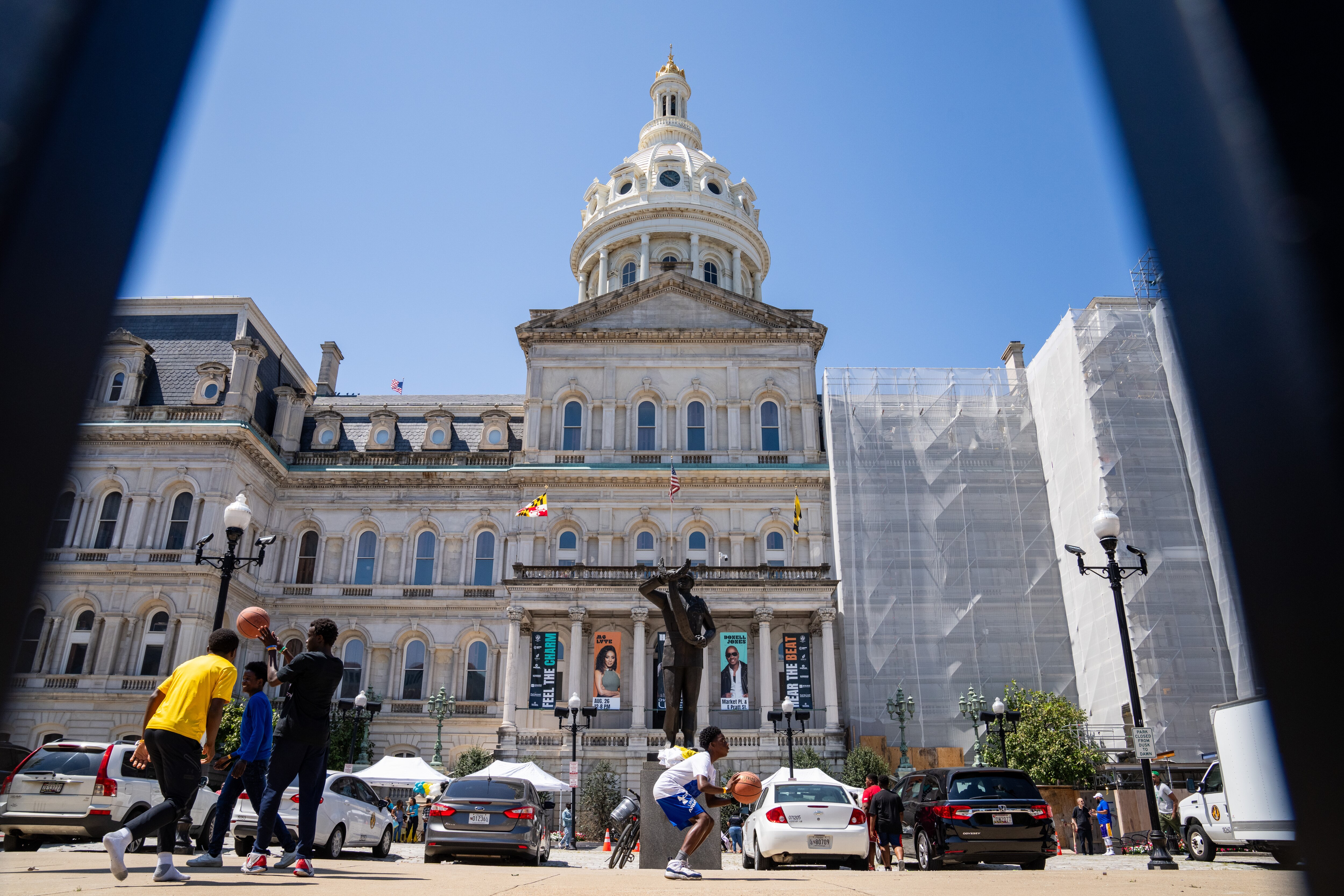 Children play basketball in front of City Hall.