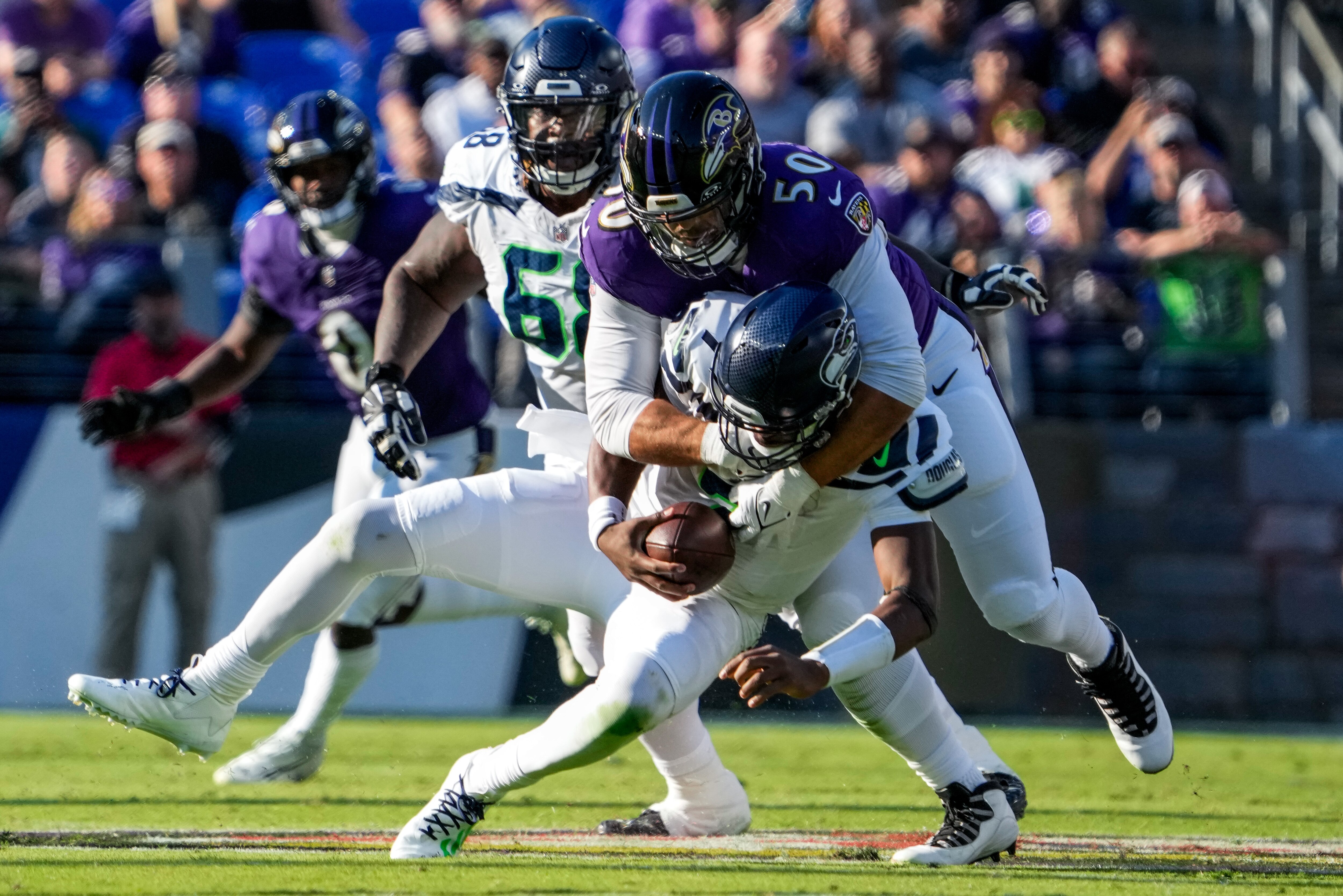 Ravens linebacker Kyle Van Noy sacks Seattle's Geno Smith during the second quarter. Van Noy had two of the team's four sacks.