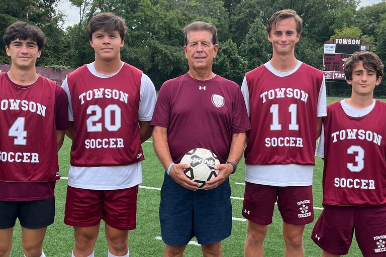 (From left) Towson High soccer captains - junior Jake DelViscio and seniors Parker Fong, Jensen Specht and Vinny Guida - flank Towson coach Randy Dase, center, at practice the day before the Generals host arch-rival Dulaney on Tuesday in the Men’s Cancer Awareness game. Dase is a cancer survivor who was treated at the Brady Urological Institute at Johns Hopkins Hospital.