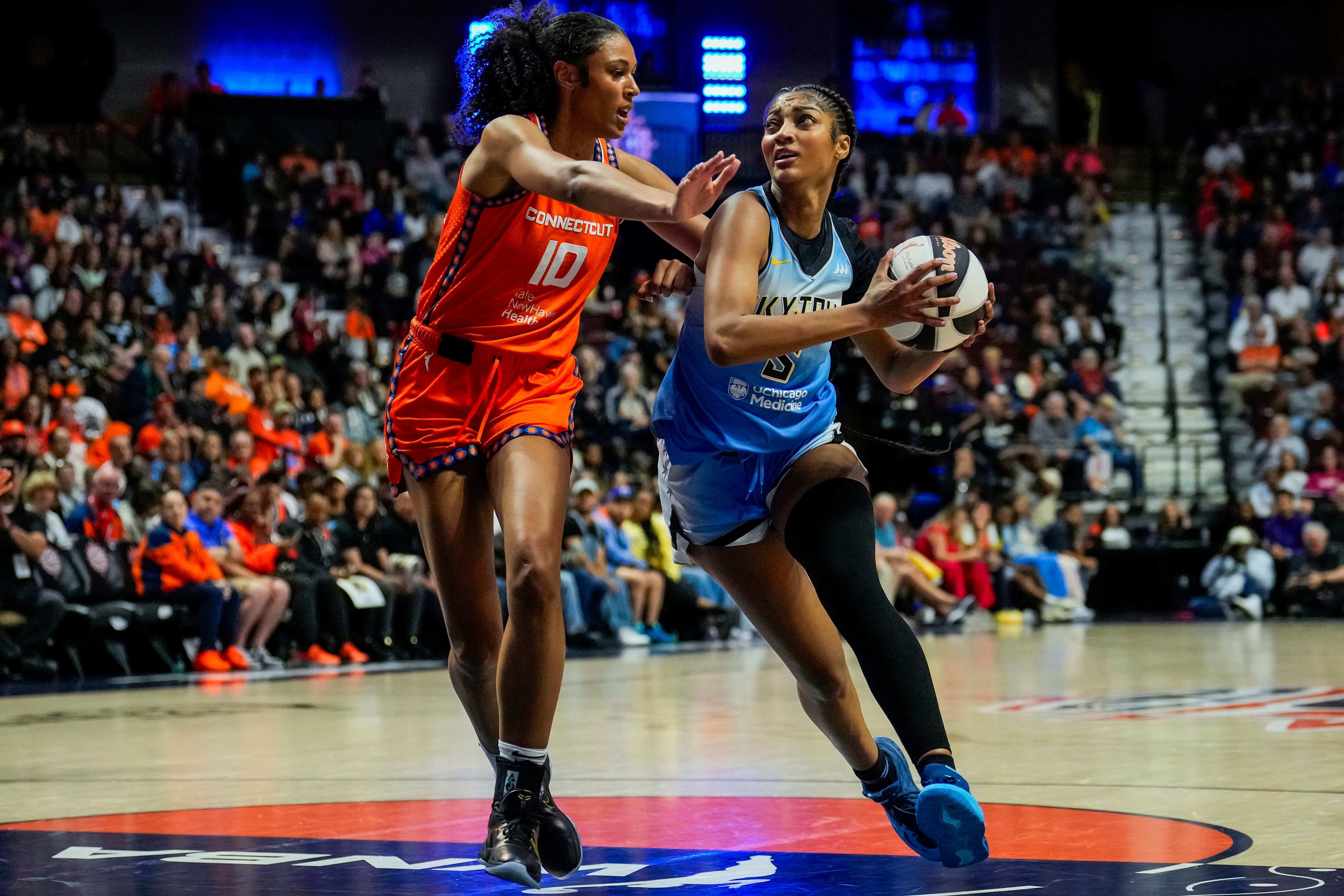 Angel Reese of the Chicago Sky drives to the rim against Olivia Nelson-Ododa of the Connecticut Sun during the second half Sunday.