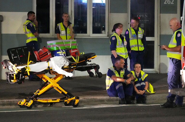 Emergency workers stand by at Bondi Beach after a reported shooting in Sydney.