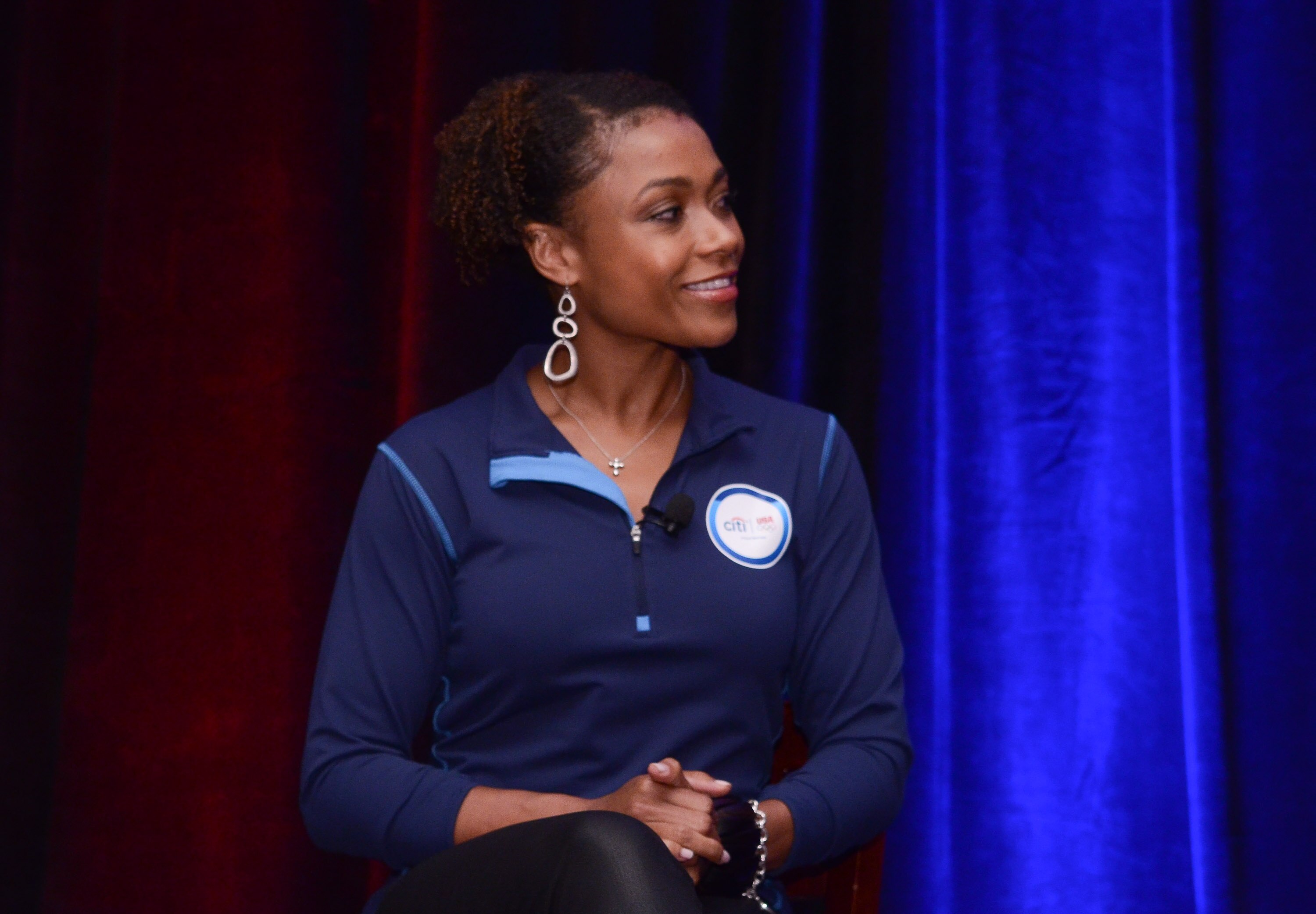 WASHINGTON, DC - MAY 09: Dominique Dawes listens during an event to celebrate Citi’s Team USA sponsorship and mark its 200th anniversary at the Hyatt Regency Washington on Capitol Hill on May 9, 2012 in Washington, D.C.
