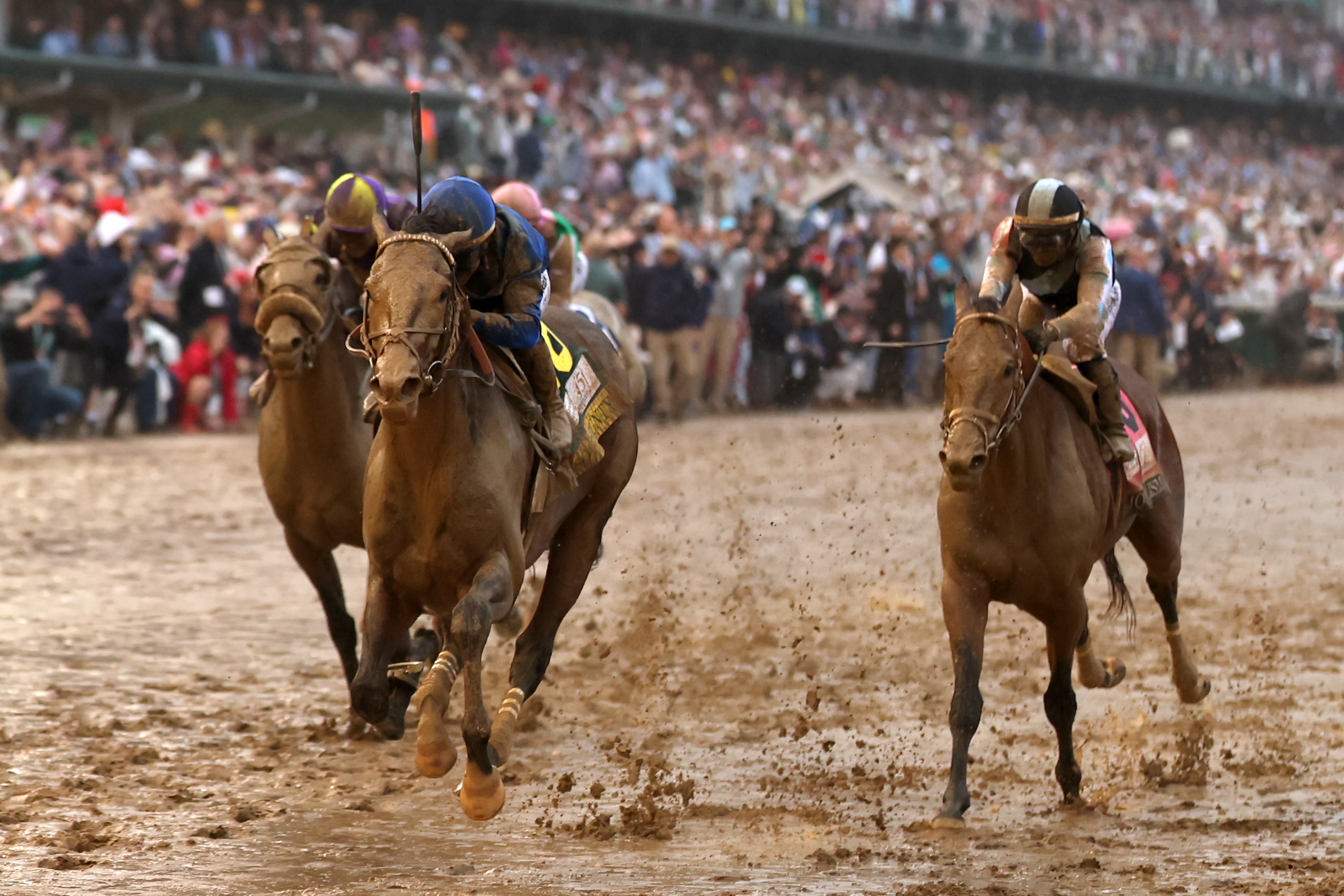 Sovereignty, center, ridden by jockey Junior Alvarado, leads the field to the finish line to win the 151st running of the Kentucky Derby.