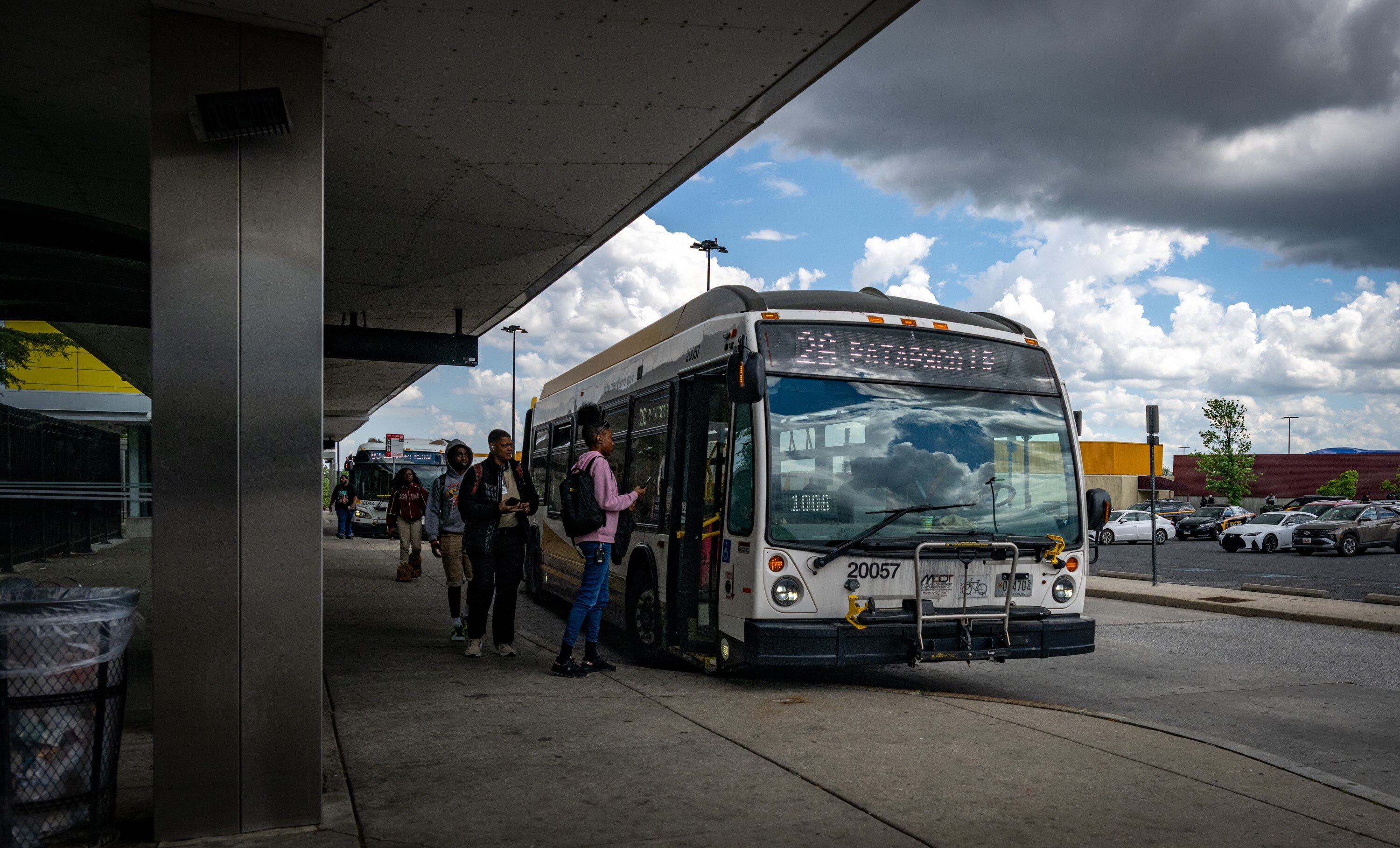 Passengers board a bus at the Mondawmin Transit Hub.
