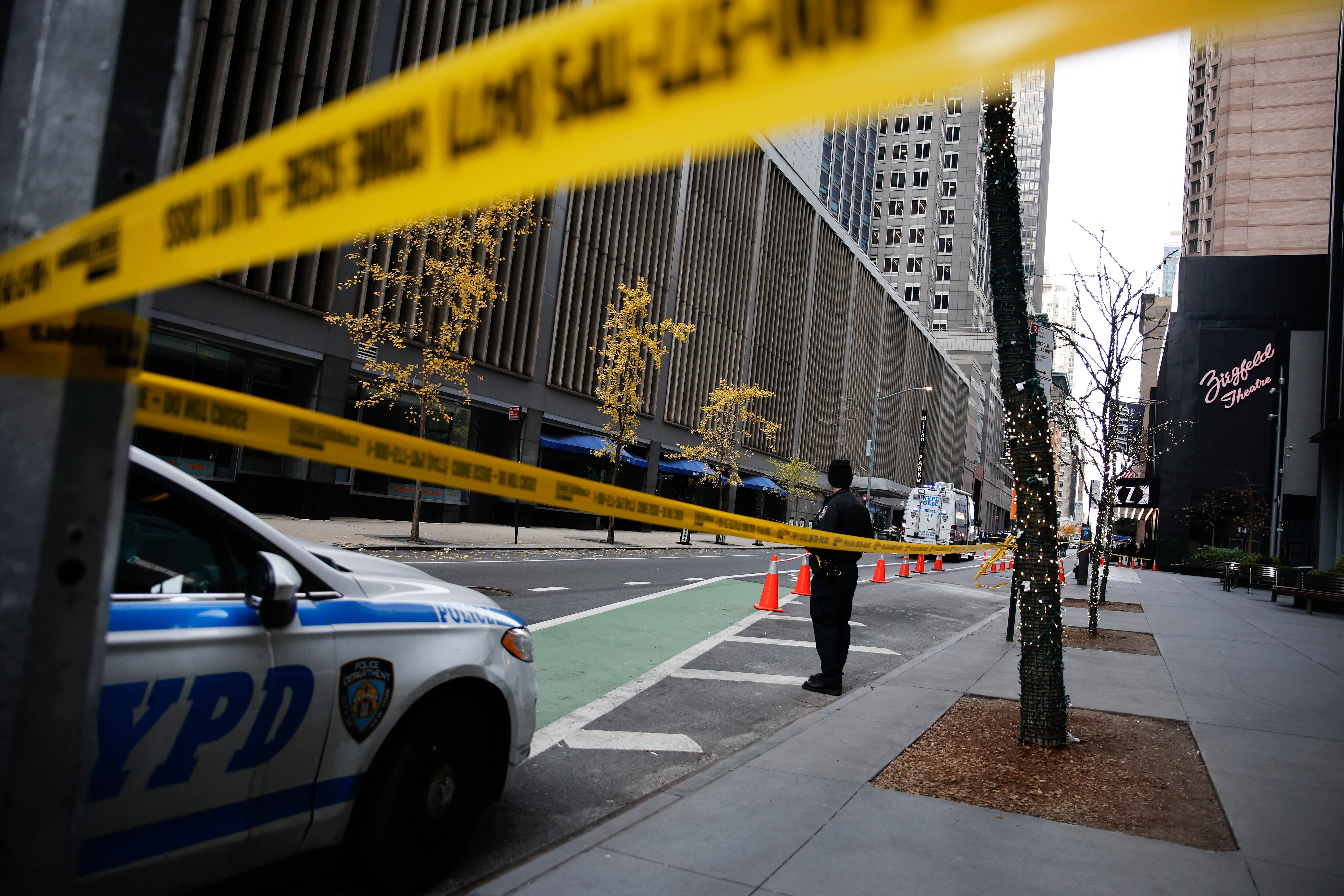 A New York police officer stands on 54th Street outside the Hilton Hotel in midtown Manhattan where Brian Thompson, the CEO of UnitedHealthcare, was fatally shot Wednesday, Dec. 4, 2024, in New York.