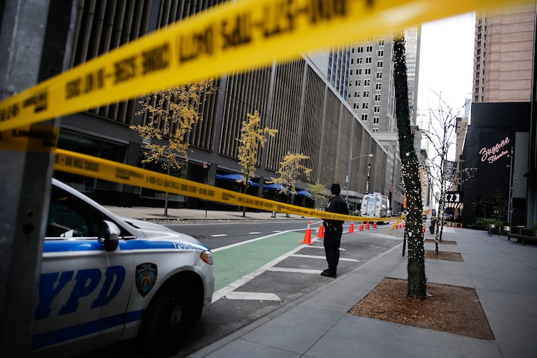 A New York police officer stands on 54th Street outside the Hilton Hotel in midtown Manhattan where Brian Thompson, the CEO of UnitedHealthcare, was fatally shot Wednesday, Dec. 4, 2024, in New York.