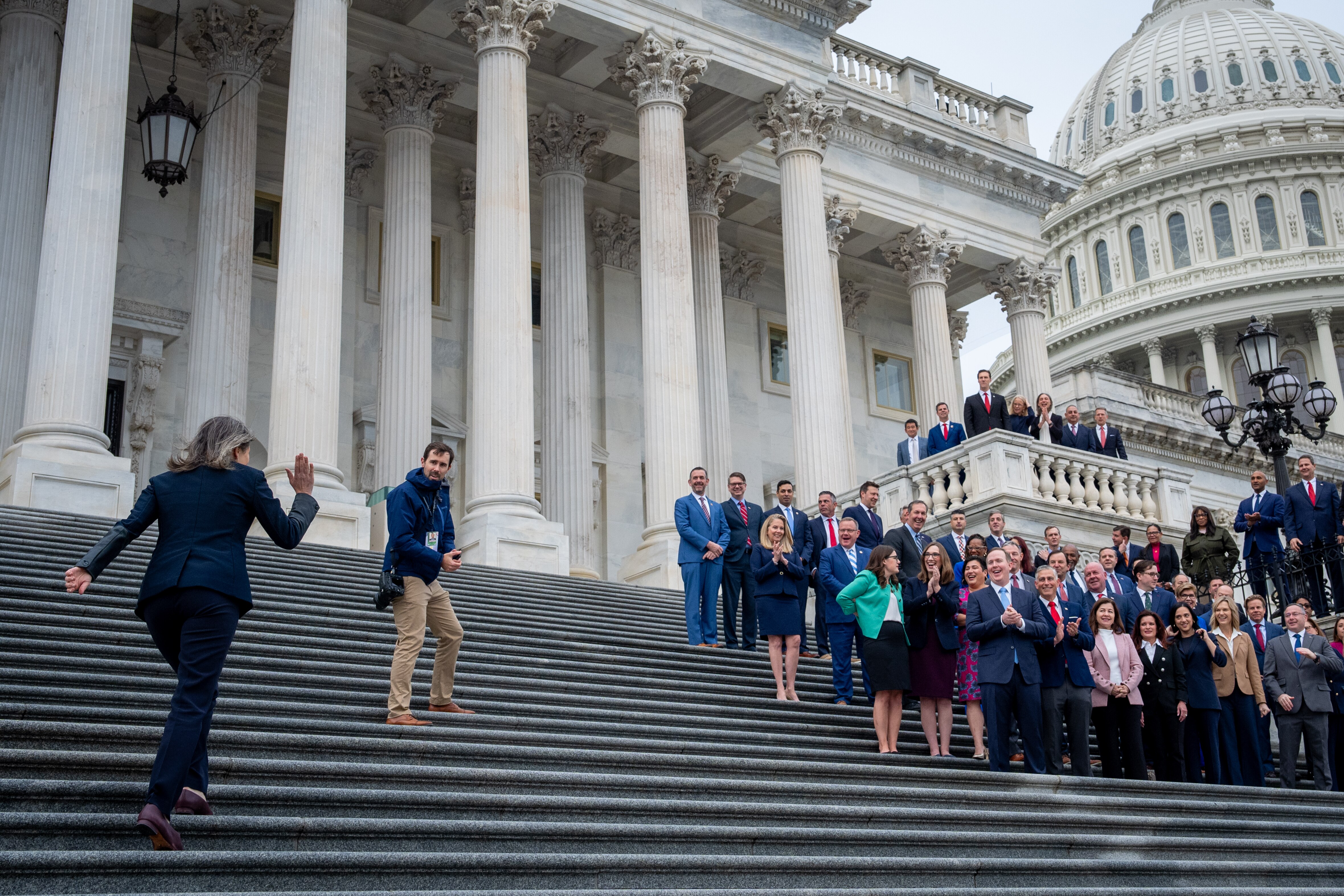 WASHINGTON, DC - NOVEMBER 15: Rep.-elect Maggie Goodlander (D-NH) (L) rushes to join other congressional freshmen of the 119th Congress as she arrives late for a group photograph on the steps of the House of Representatives at the U.S. Capitol Building on November 15, 2024 in Washington, DC. New members of congress are in-town for an orientation program to help them prepare for their upcoming roles.