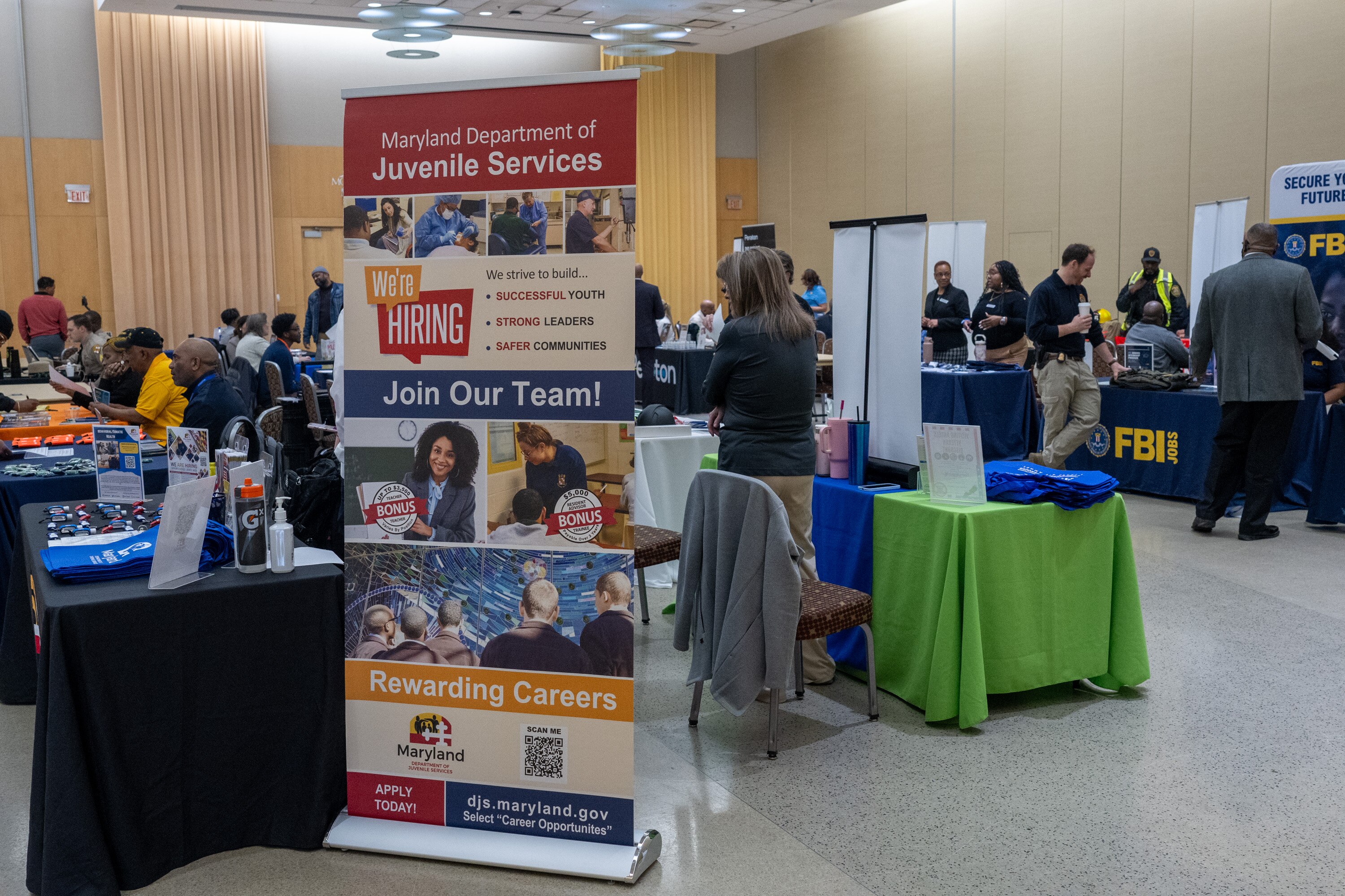 Recruiters talks to potential candidates at a hiring fair for veterans and other community members at Morgan State University.