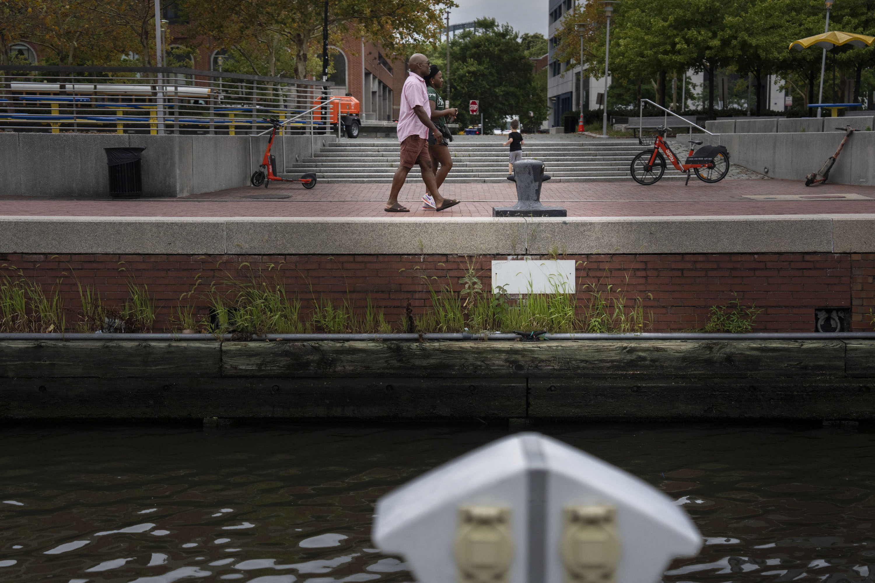 A couple walks adjacent to the pier at Baltimore's Inner Harbor.