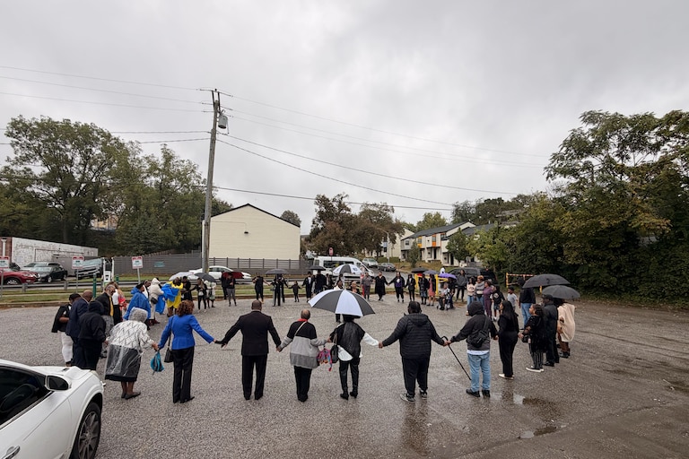 Community members gathered at the Leon Day Park Sunday morning to hold a prayer circle for a 12-year-old girl killed in a shooting there during a homecoming football game on Oct. 3 after two men got into a dispute over parking.