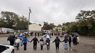 Community members gathered at the Leon Day Park Sunday morning to hold a prayer circle for a 12-year-old girl killed in a shooting there during a homecoming football game on Oct. 3 after two men got into a dispute over parking.