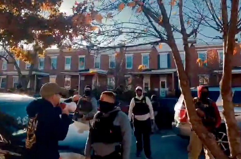 A still from a video showing Baltimore resident Clifford “Buzz” Grambo as he confronts apparent immigration agents on a Southeast Baltimore residential street Sunday morning.