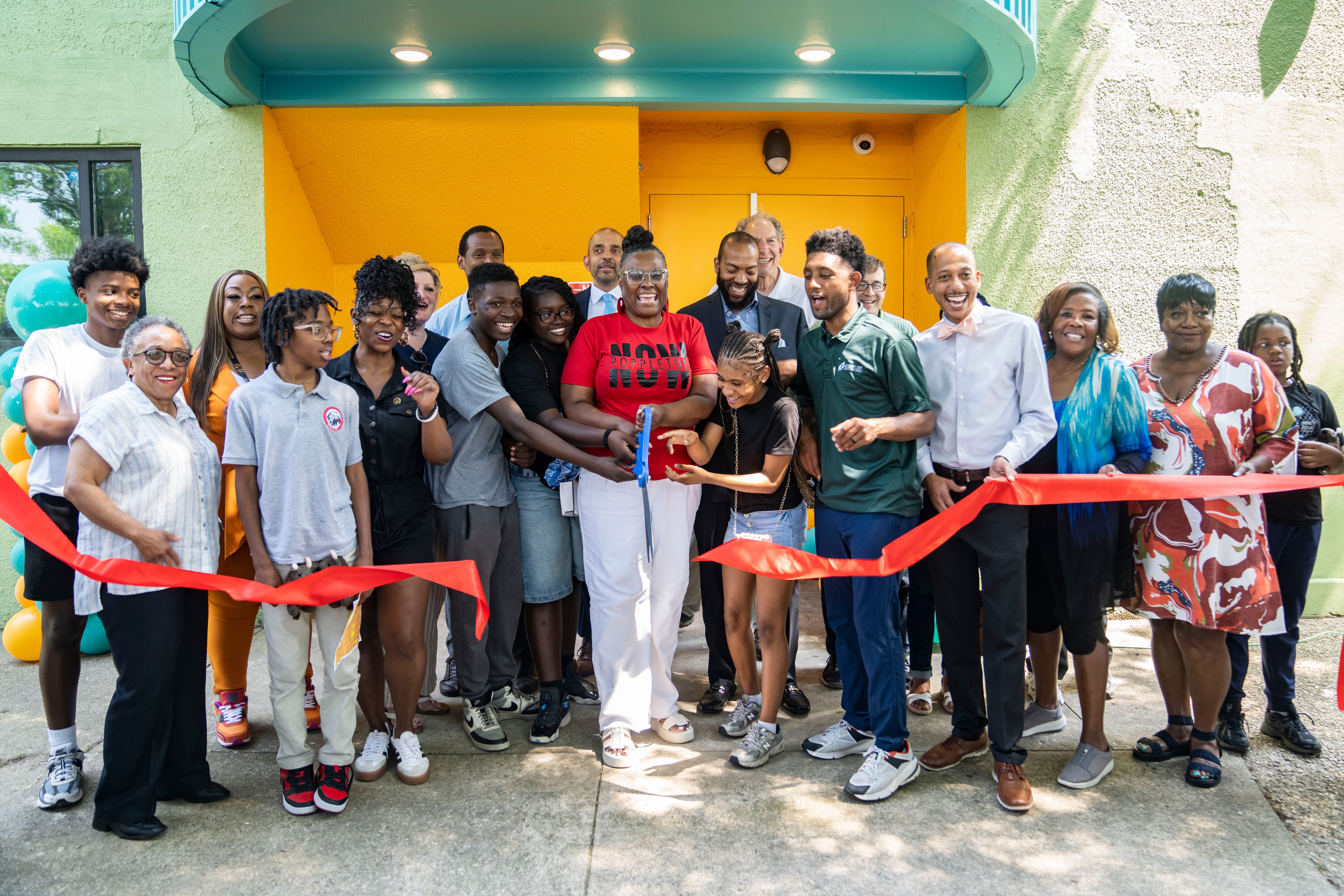 Sonia Eaddy, center, conducts a ribbon cutting during the reopening of The Poppleton Recreation Center on Thursday afternoon.