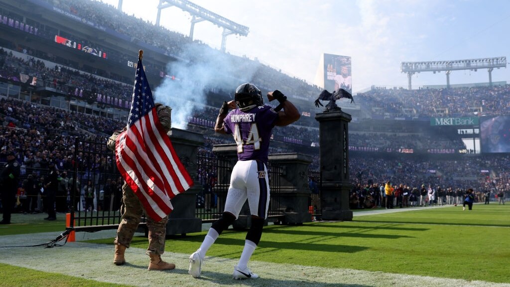 BALTIMORE, MARYLAND - NOVEMBER 12: Marlon Humphrey #44 of the Baltimore Ravens takes the field with a military member before the game against the Cleveland Browns at M&T Bank Stadium on November 12, 2023 in Baltimore, Maryland. (Photo by Todd Olszewski/Getty Images)