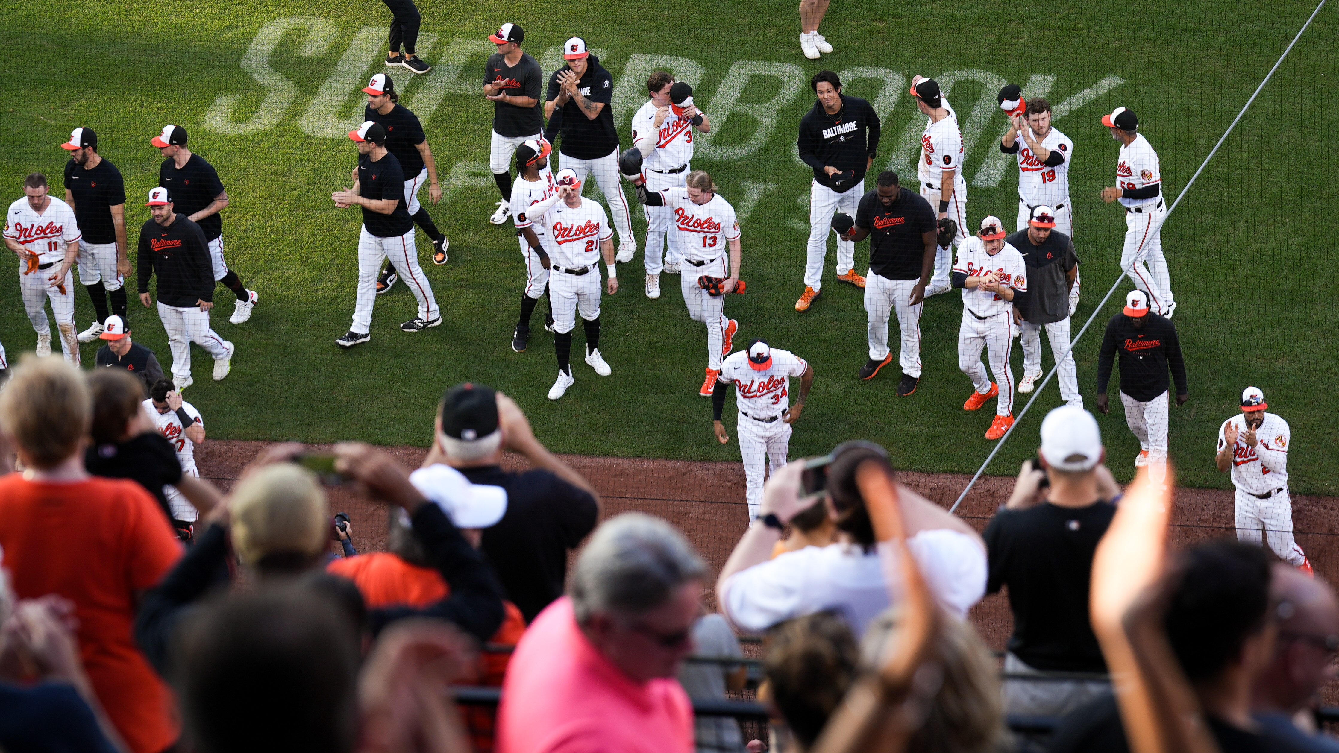 The Orioles receive a standing ovation from the Camden Yards crowd after Sunday's regular-season finale.