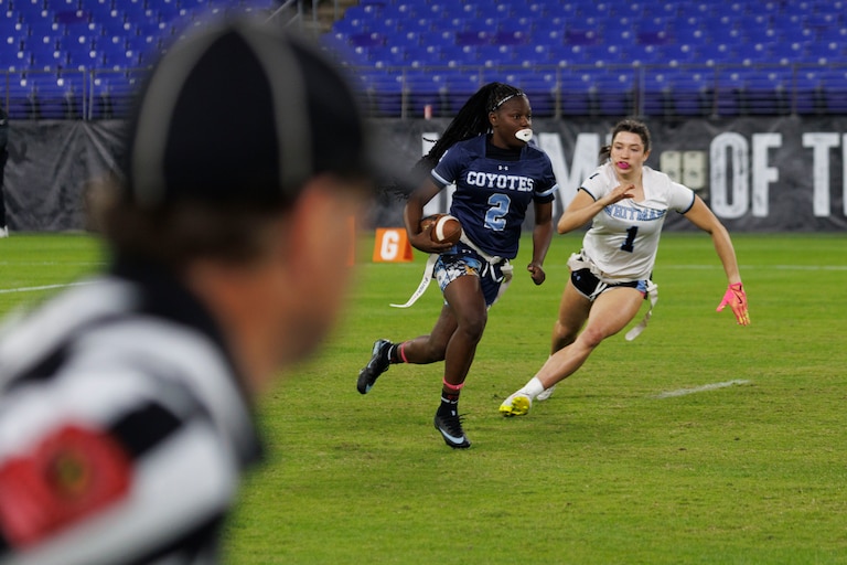 Clarkburg's Aysia Jones Robinson runs with the ball as Whitman's Charlotte Dorsey chases.