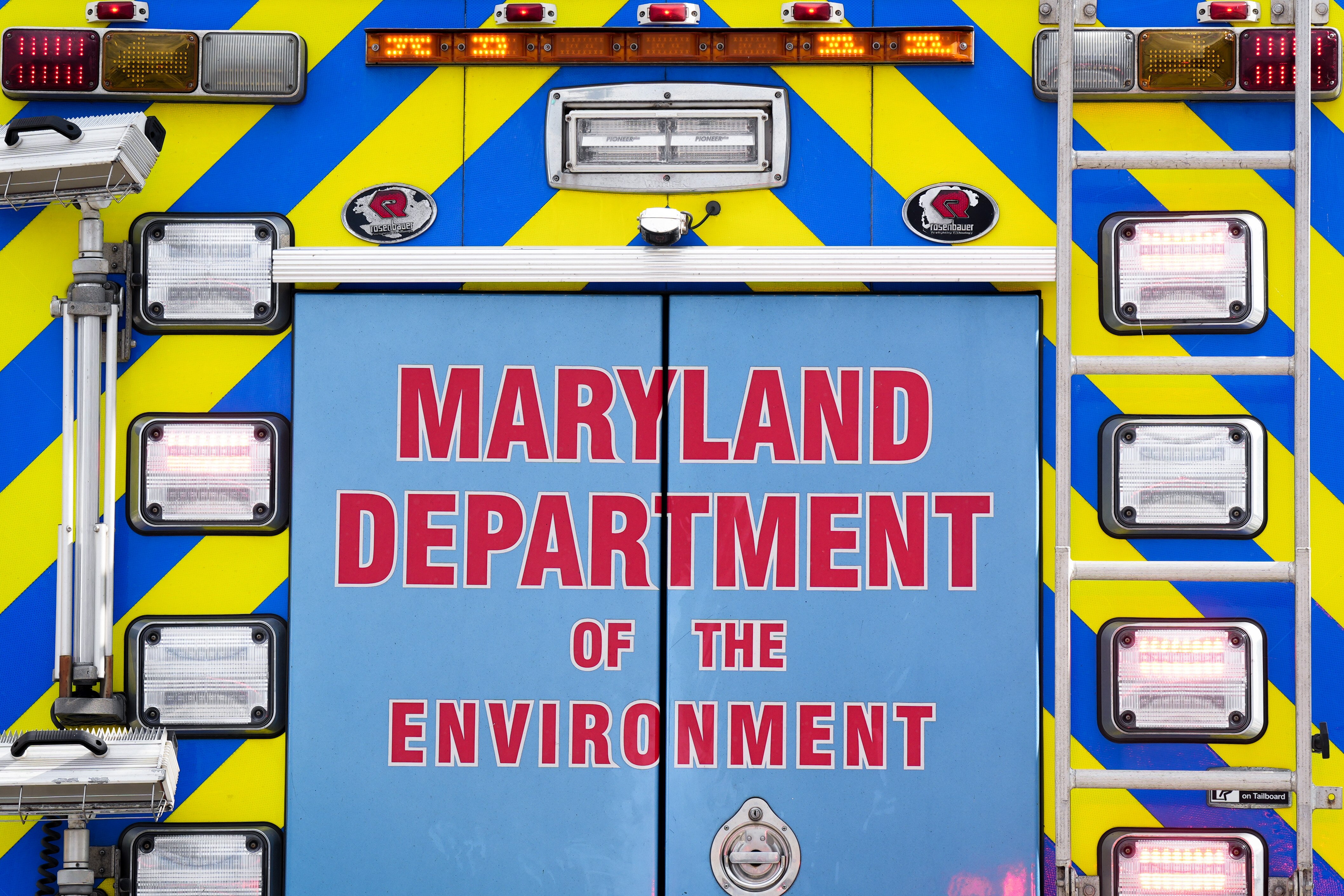 A Maryland Department of the Environment vehicle remains on the scene after a vehicle exploded inside a five-story parking garage in Baltimore’s Fells Point neighborhood on July 27, 2022.