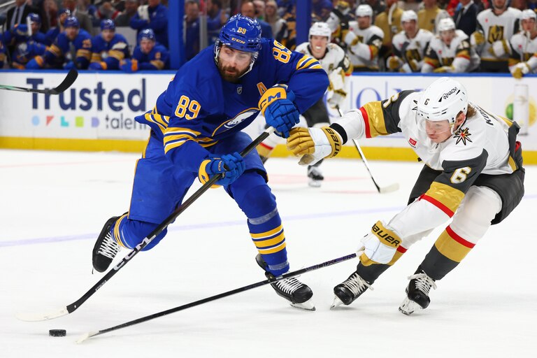 FILE - Buffalo Sabres right wing Alex Tuch (89) is stick checked by Vegas Golden Knights defenseman Kaedan Korczak (6) during the first period on March 3.