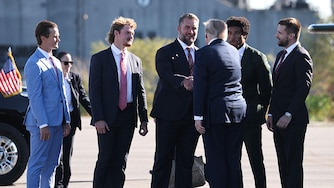 President Donald Trump greets members of the Baltimore Ravens, from left to right, kicker Tyler Loop, punter Ryan Eckley, long snapper Nick Moore and cornerback Marlon Humphrey, and political consultant Alex Bruesewitz as he arrives to speak at Tradepoint Atlantic on Tuesday.